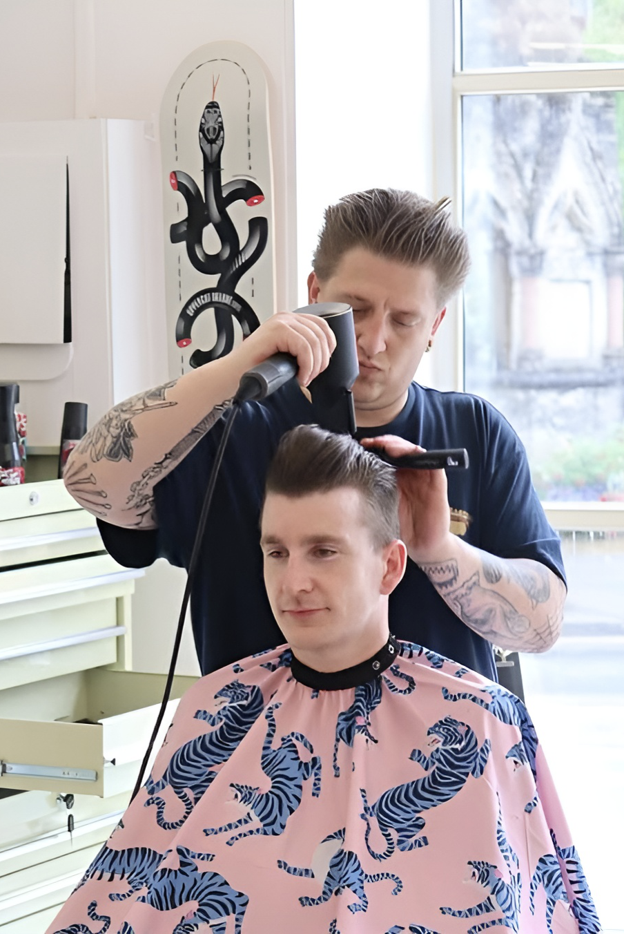 Ironworks Barbers' Owner and Senior Barber, Ryan, shaping and perfecting the cut for a regular.