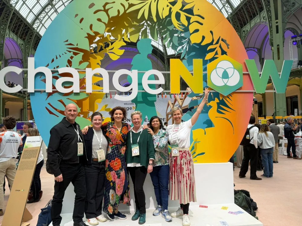 Liz and DisComcierge cohort at 2026 ChangeNOW event stood infront of the ChangeNow sign.