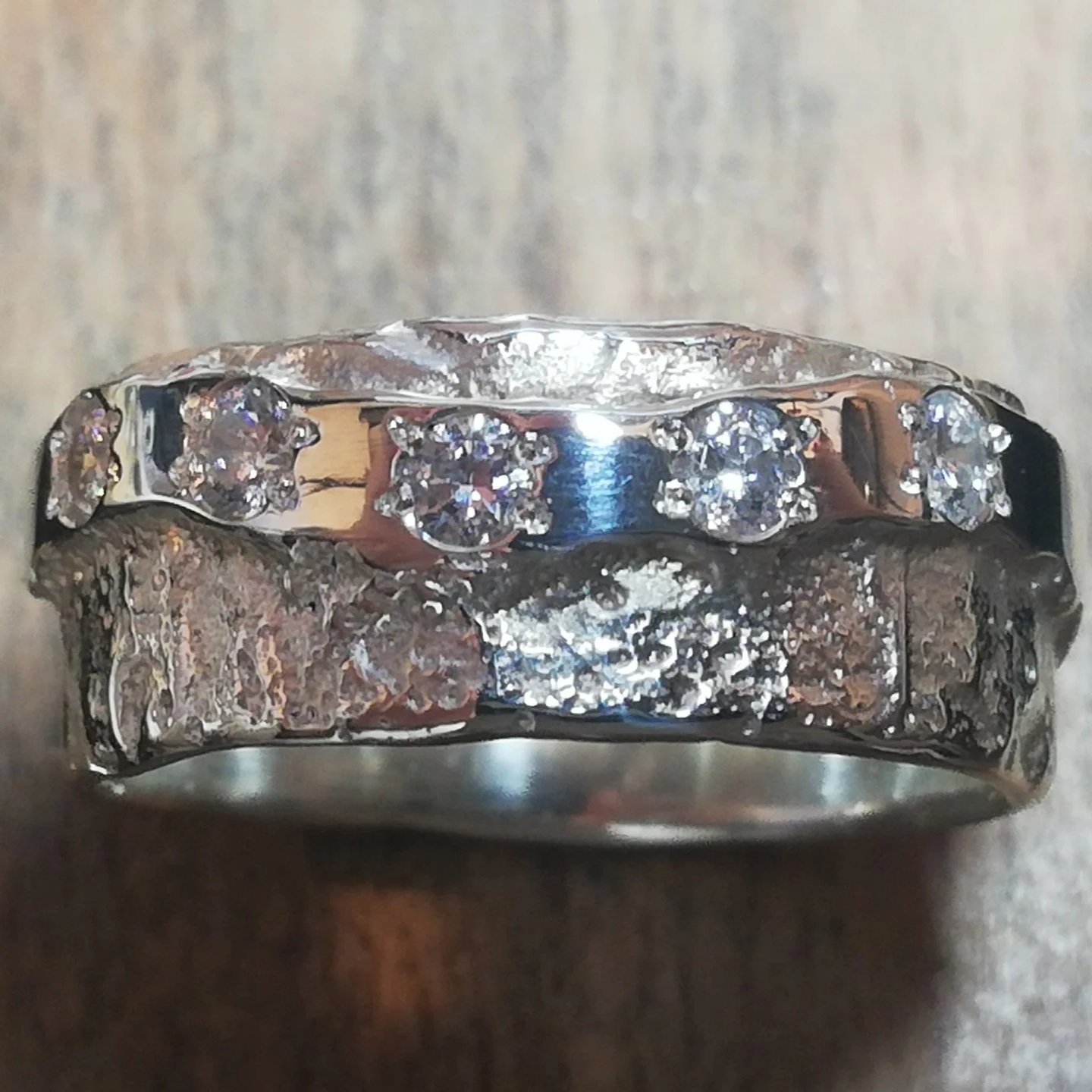 silver ring with waved band of cz stones