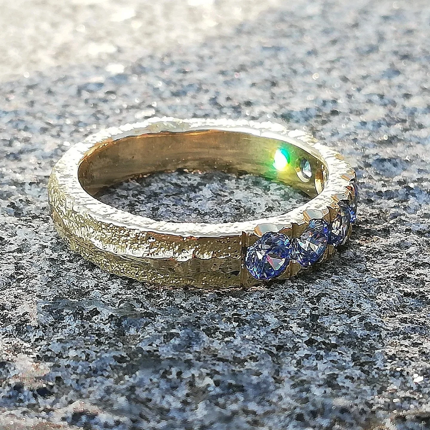 shiny stones in old gold ring