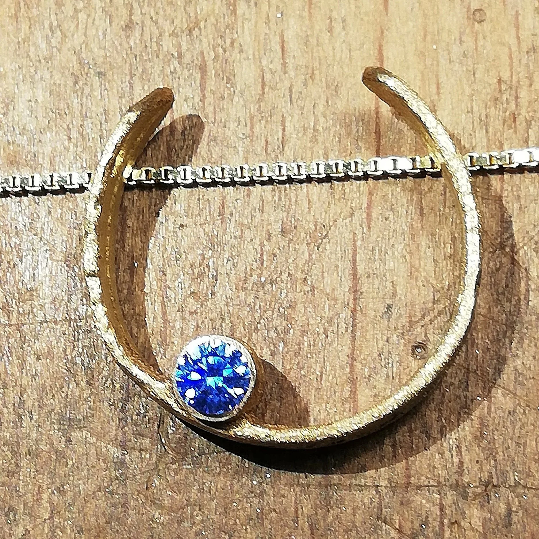 gold pendant with artic blue cz