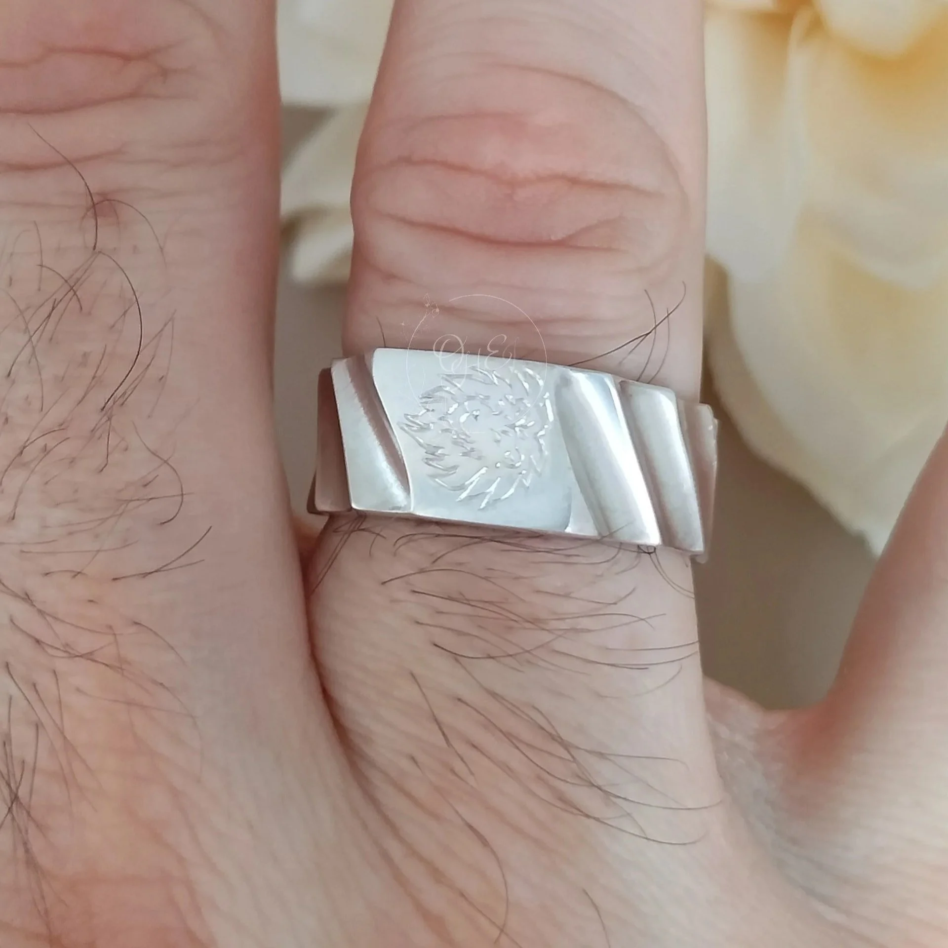 Signet ring on men's hand, handengraved by OrfaHandEngraving