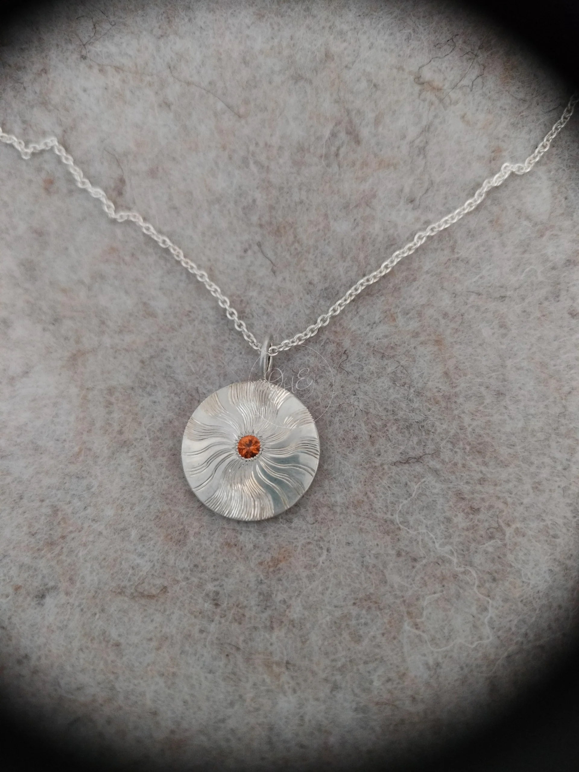 Shiny pendant with orange gemstone hand engraved made by Orfa