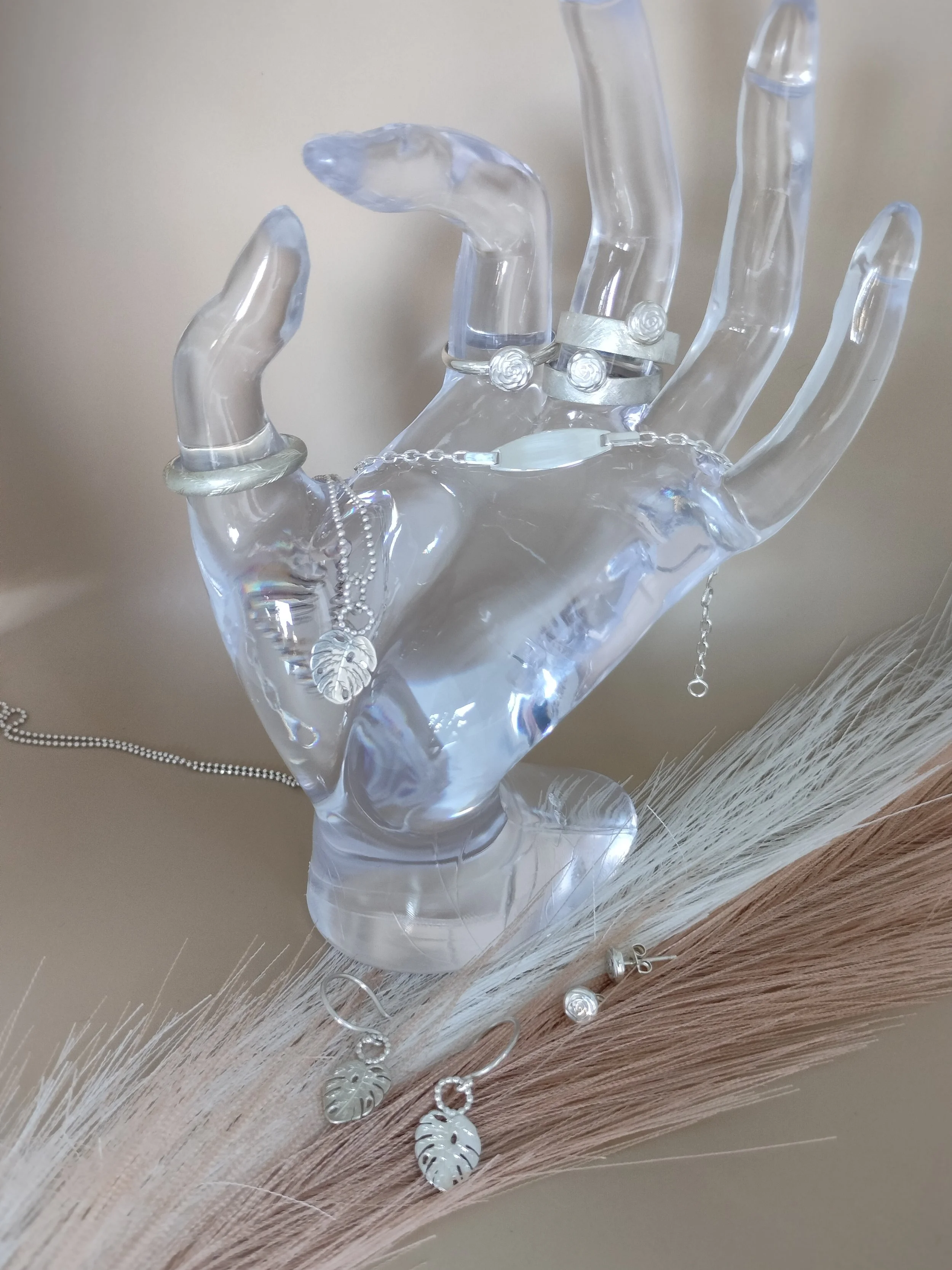 jewelry collection presented on a glass hand