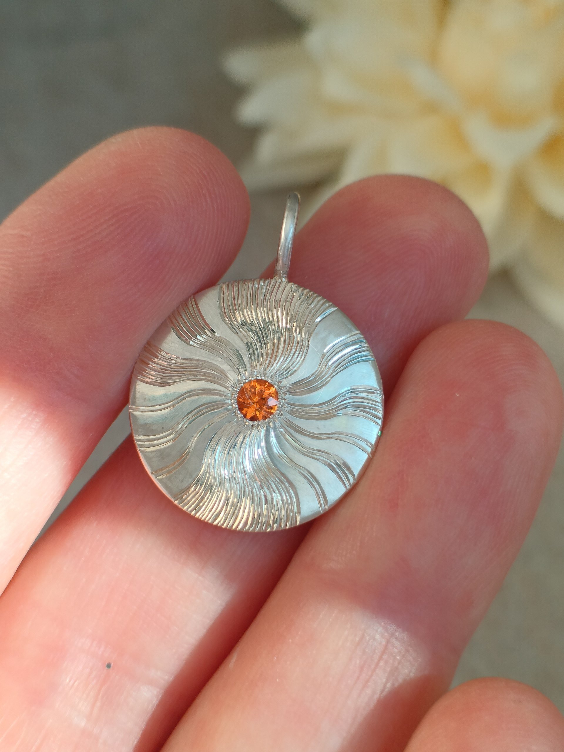 silver pendant with corund gemstone and hand engraved subbeams