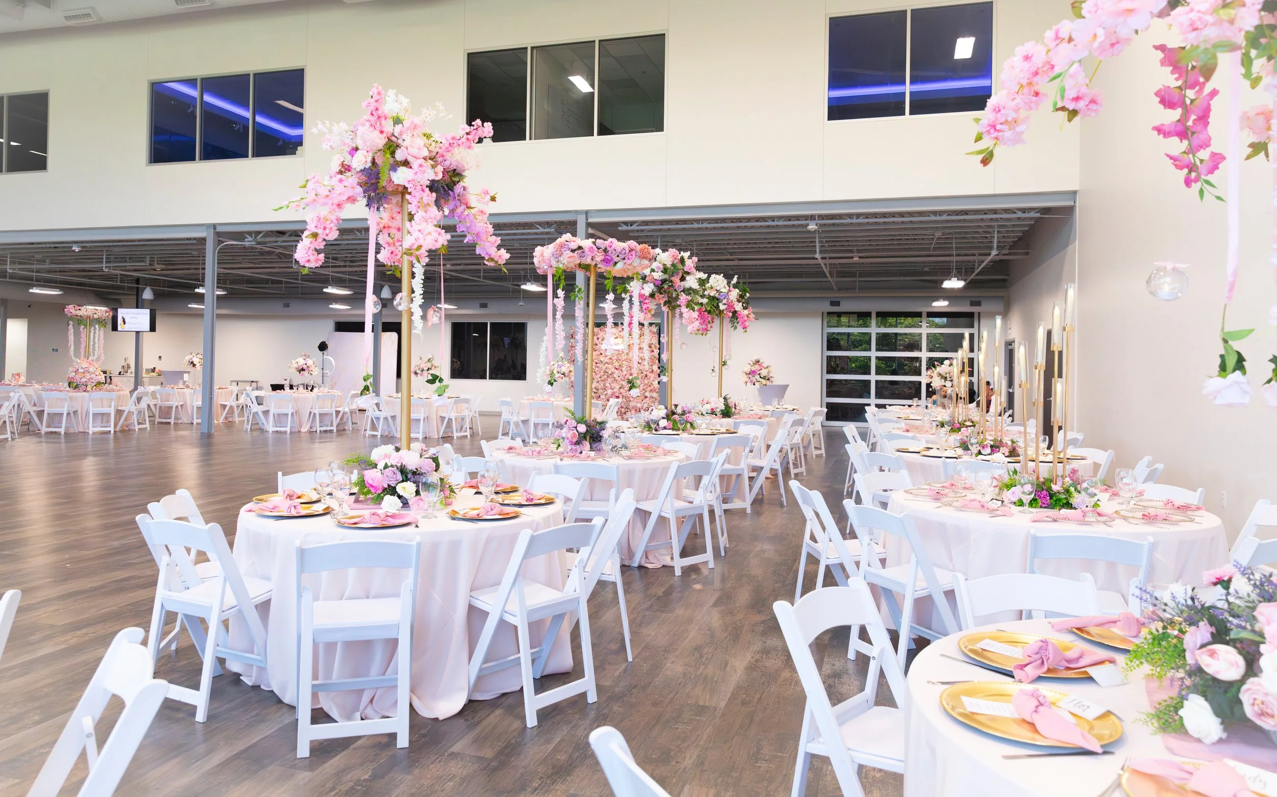 Elegant event table setup with floral décor in ballroom at The Grand View Mansfield