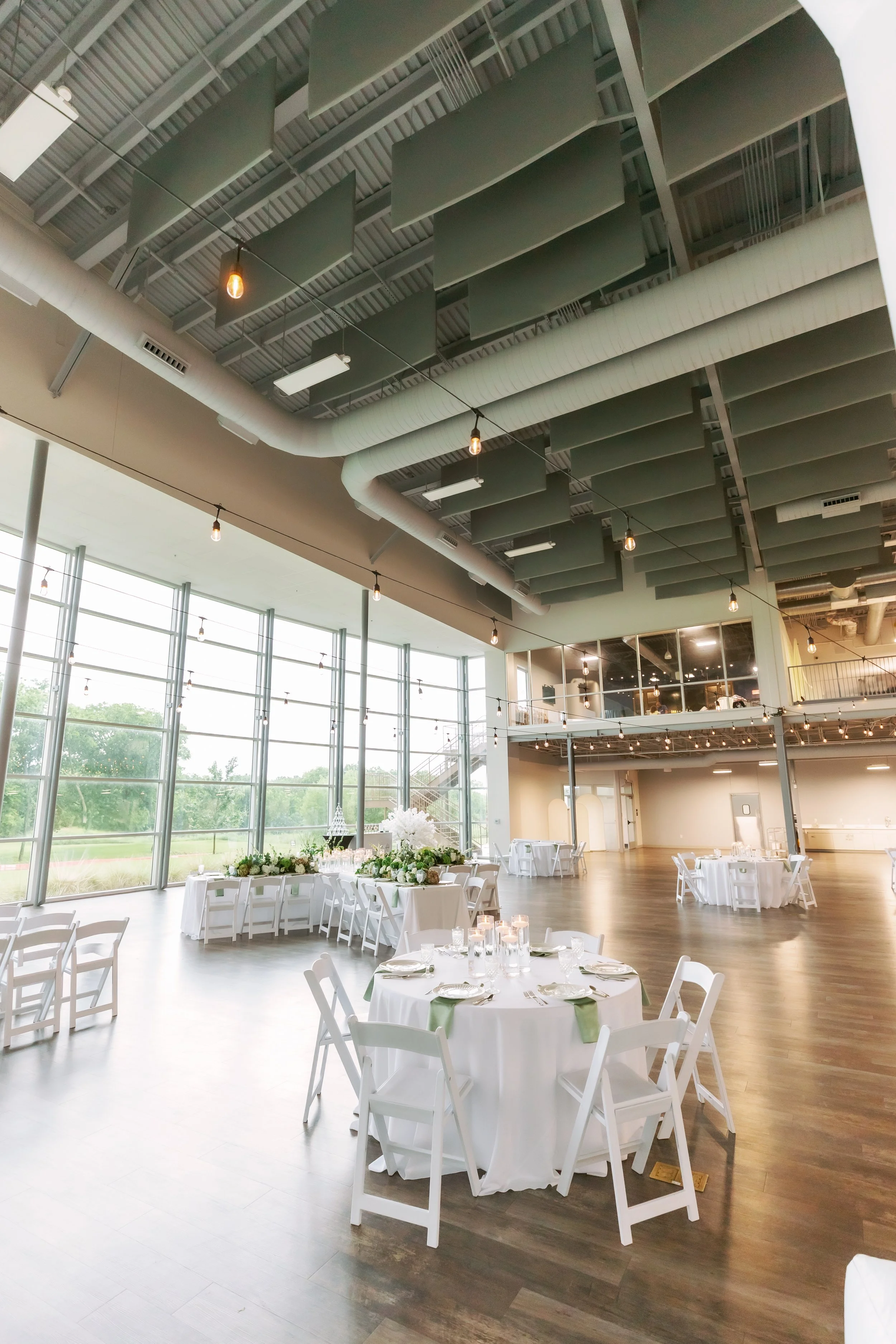 Ballroom event setup with round tables and large windows at The Grand View Mansfield event venue