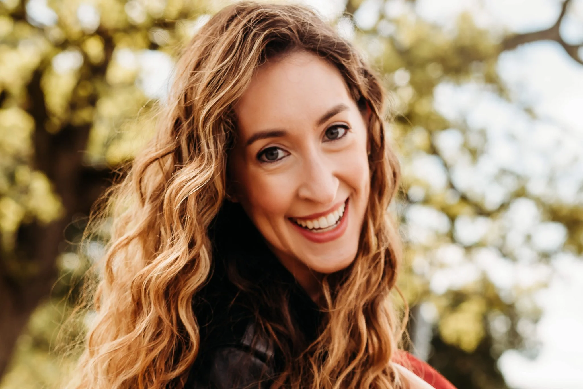 Dr. Tara Tarantino, woman smiling with long wavy hair, board-certified family medicine and osteopathic physician