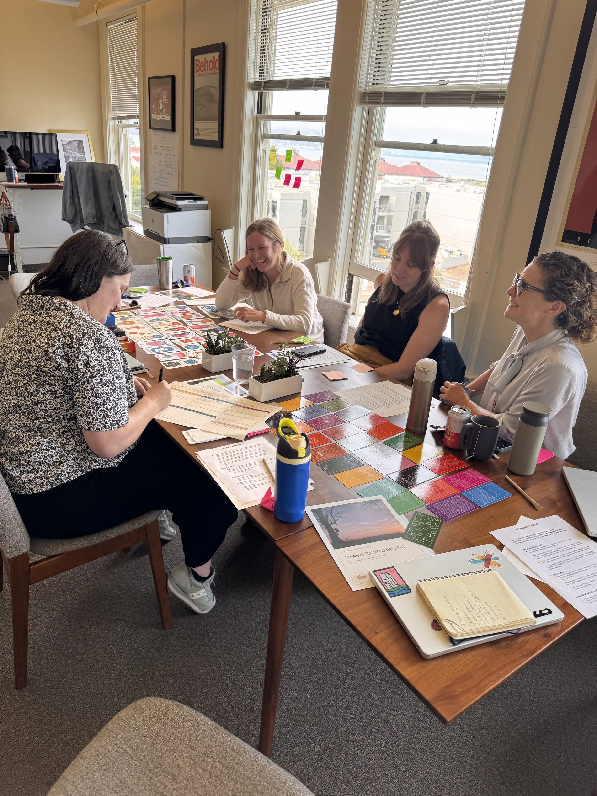 The Redford Center team building stories with story cards around a conference table