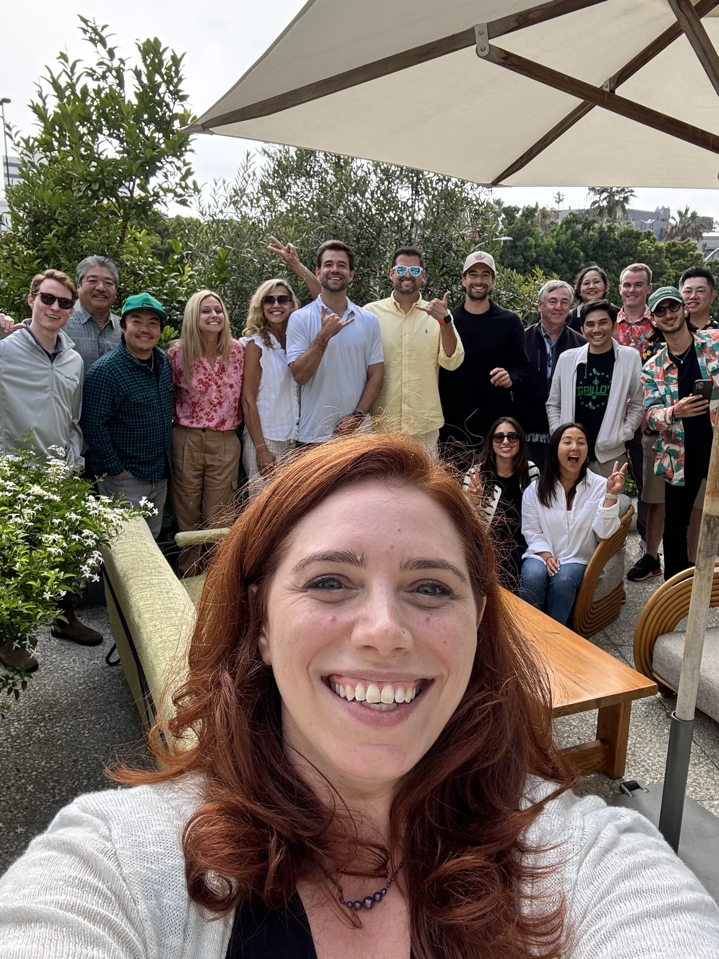 Liz Morrison taking a selfie with a large team at an outdoor company offsite workshop