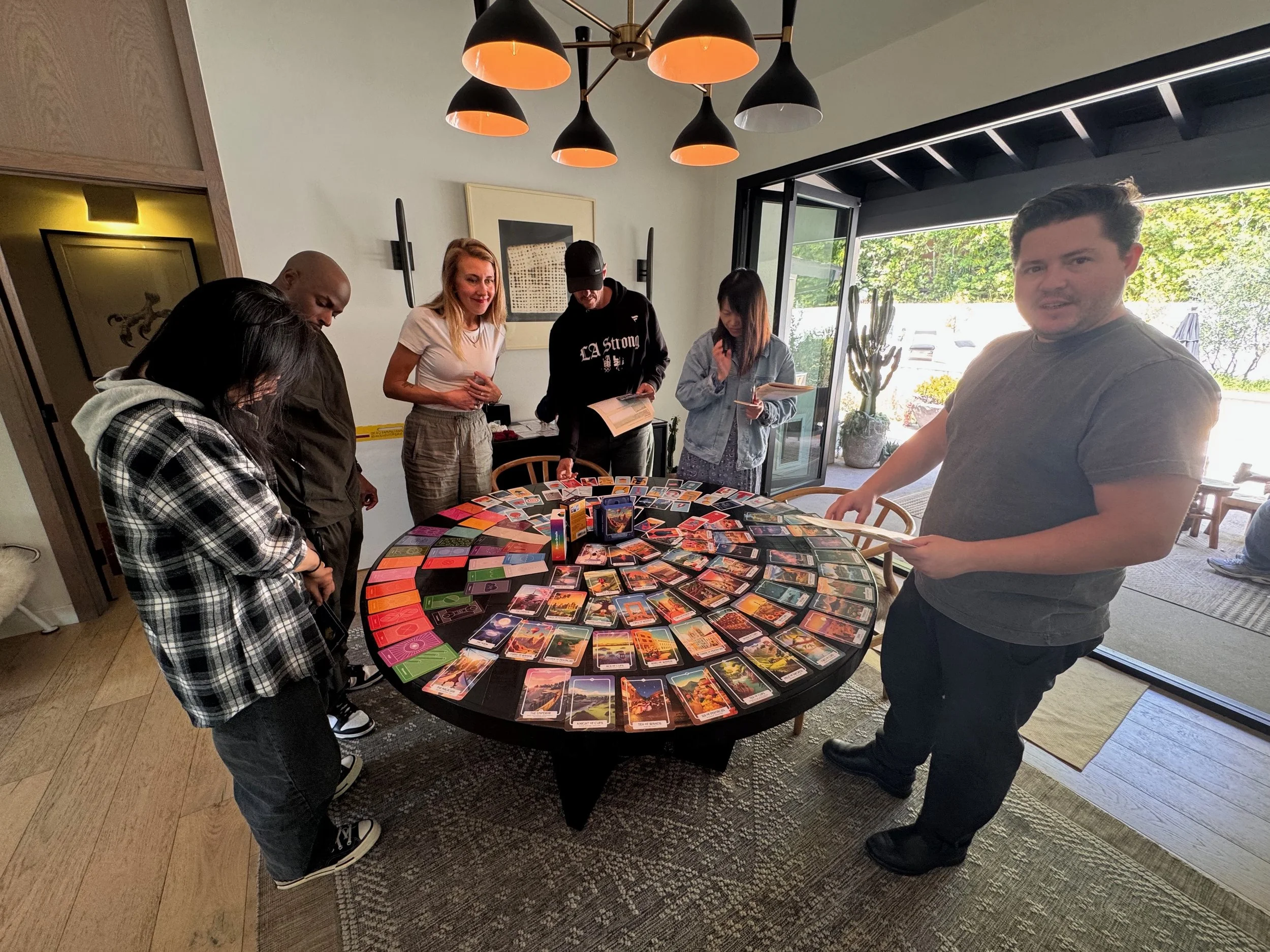 Airbnb team gathered around a table of colorful story cards during a storytelling workshop