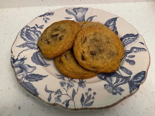 Chocolate chip cookies on a blue floral plate.