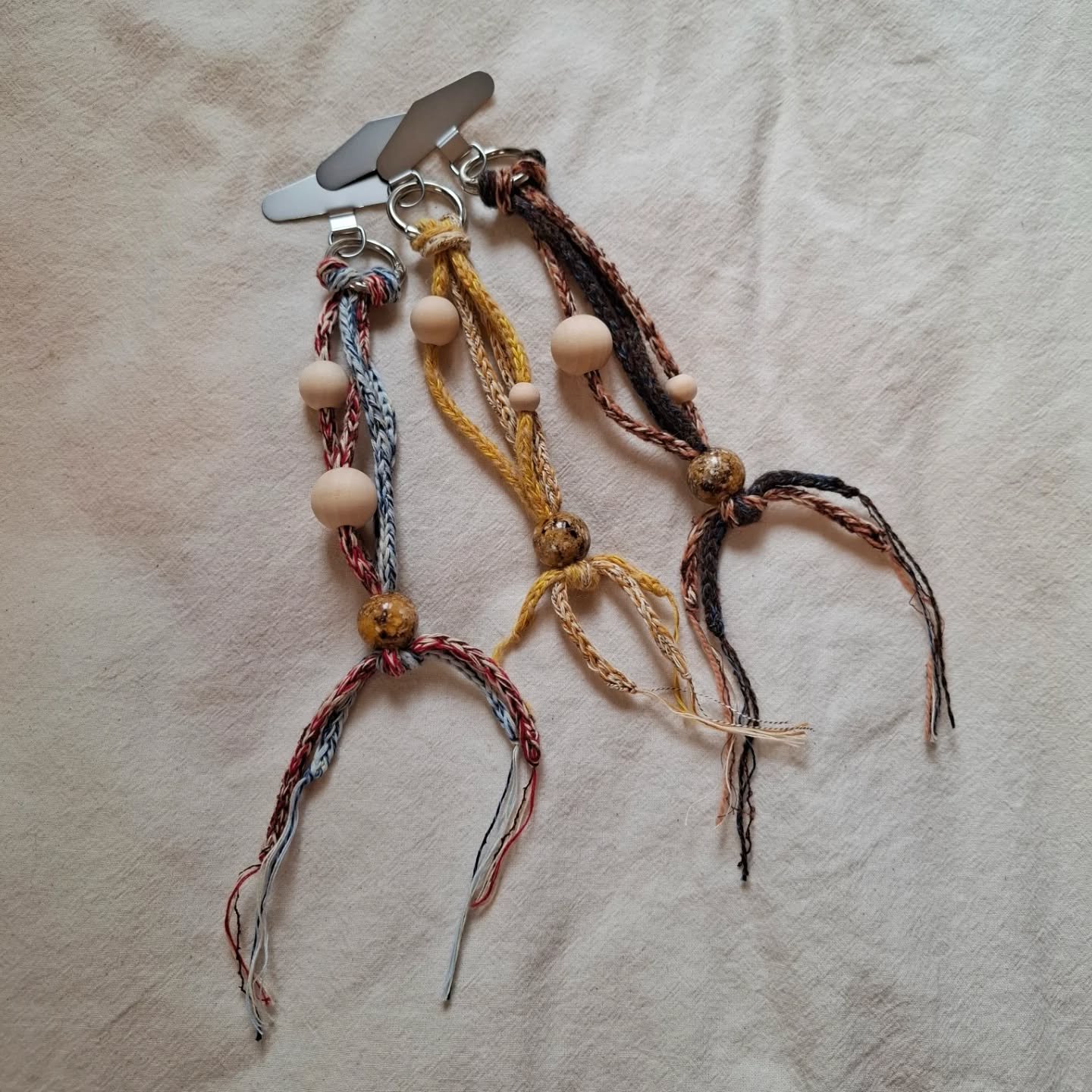 Knitted phone straps, to protect and accessorise your mobiles 📞📞📞

Each made from two icord straps knitted from 100% deadstock yarns. Threaded with wooden beads to fidget with all day long.

Finished with the option of silver or black clasps and m