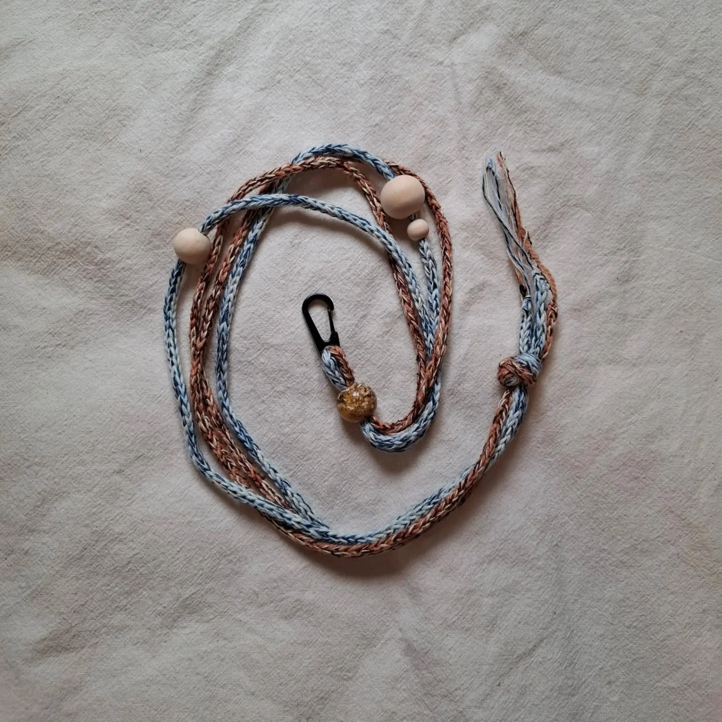 Knitted lanyard for your phone or coin purse 

○&bull;&deg; Knitted from deadstock yarns in a mix of wool and cotton. Assembled with both black and silver metal clasps and delicate beads &deg;&bull;○

Avaible on my website - link in bio 

And will be