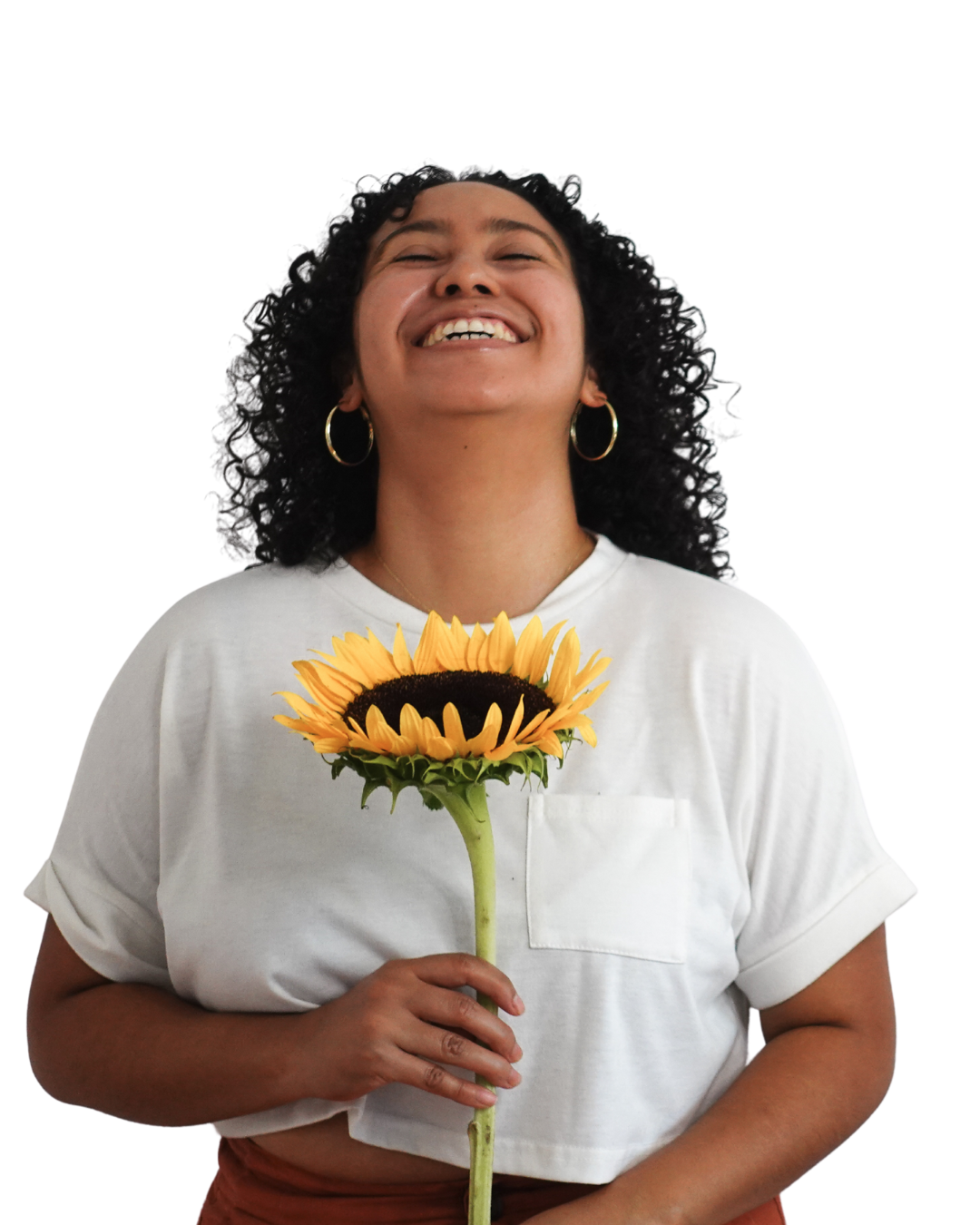 Book coach Sabrina throws her head back and laughs while holding a sunflower.