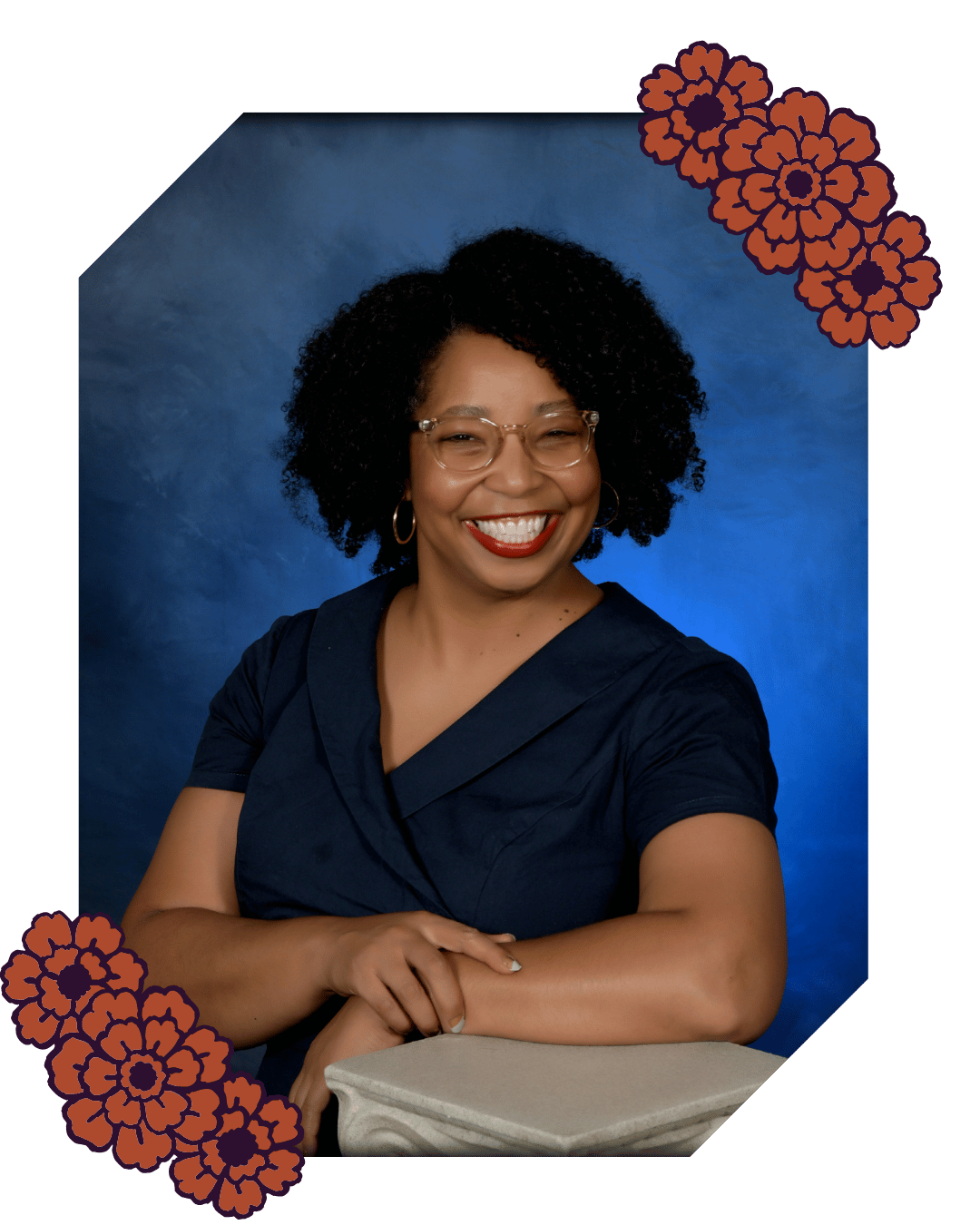 Unpolished Writers Club member Roshaunda stands in a navy shirt in front of a blue background and smiles at the camera.
