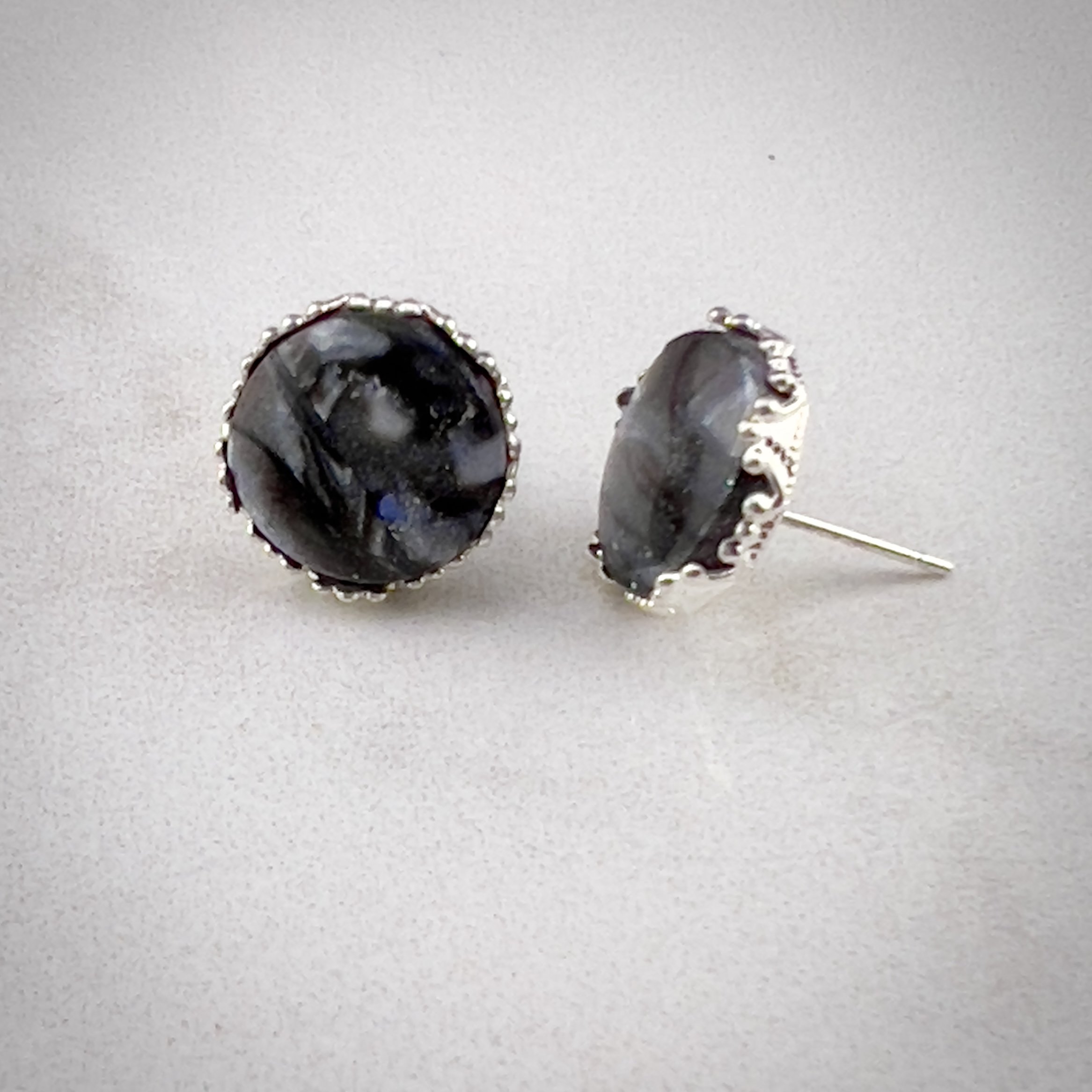 Black and gray marble studs in a silver crown setting
