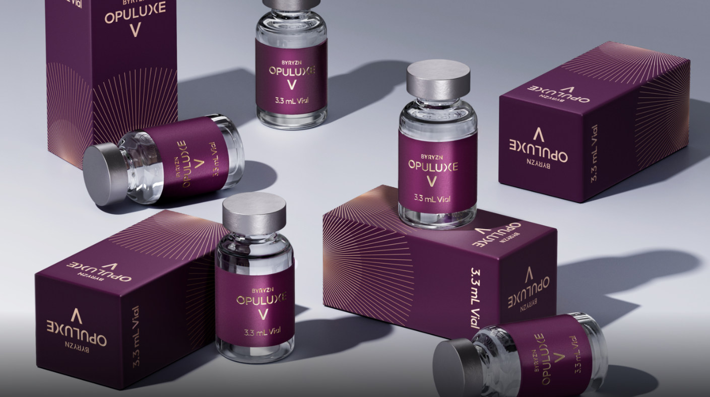 Multiple small glass vials labeled 'OpuluXe V' and '3.3 mL Vial' with purple labels, along with matching purple boxes, are arranged on a gray surface. The boxes have a starburst pattern and are labeled with the same text.