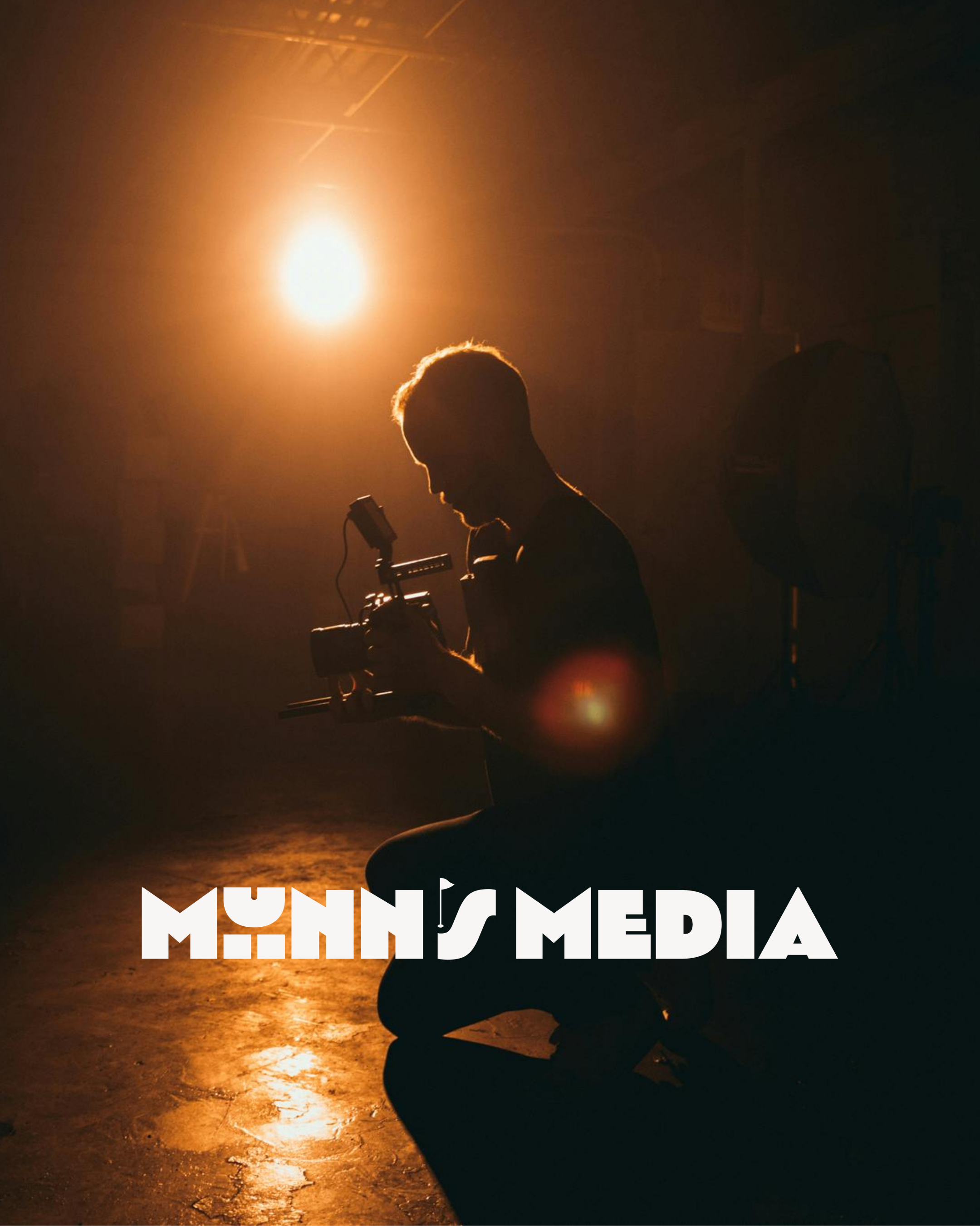 Silhouette of a person sitting cross-legged on the ground, holding a camera, in front of a bright orange sunset with the text 'MENTAL HEALTH' overlaid in white at the bottom.