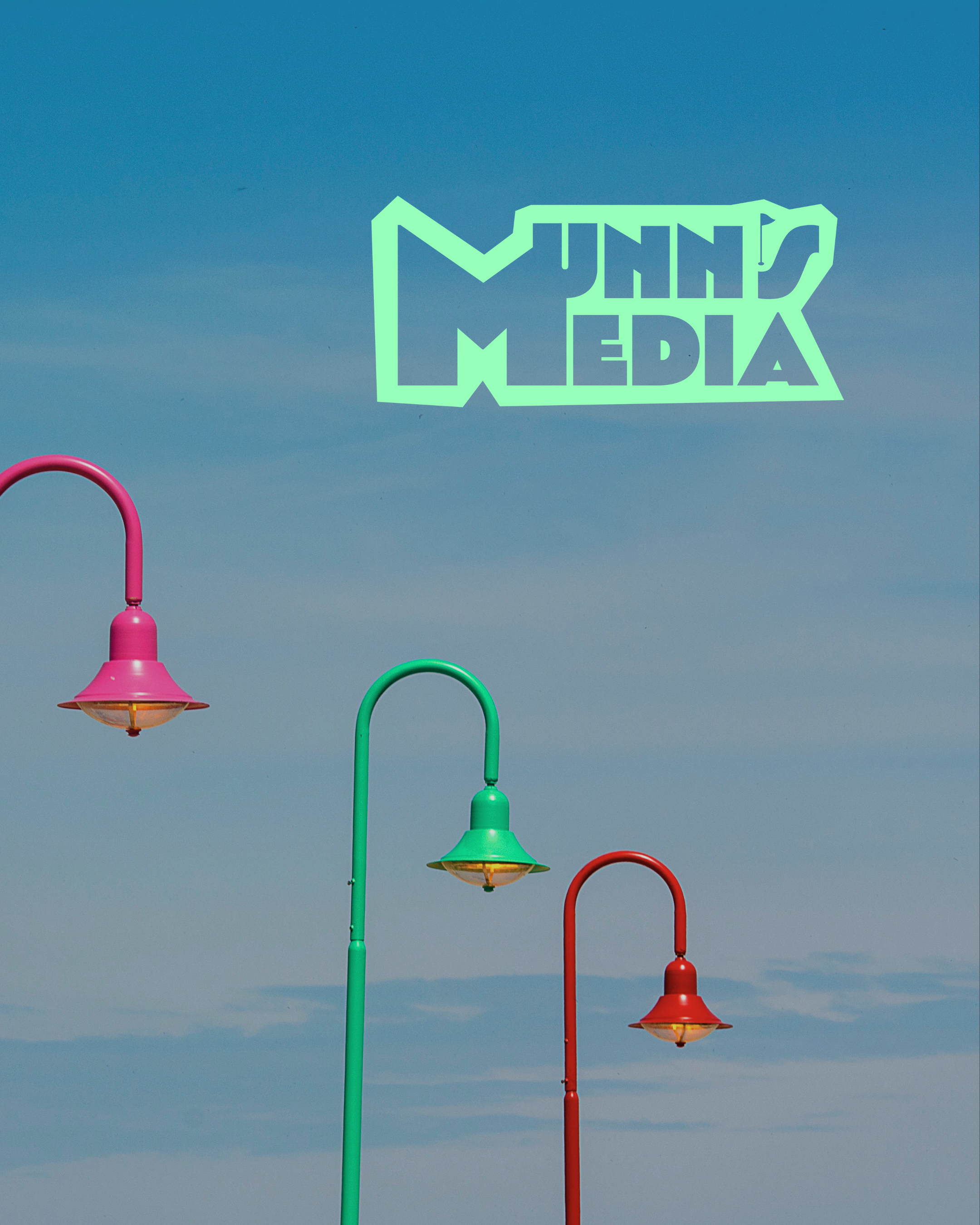 Colorful street lamps against a blue sky.