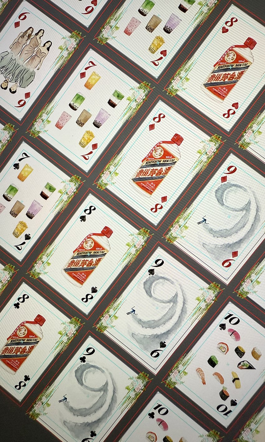 Photo of illustrated playing cards being paginated on a computer screen, ready for print.