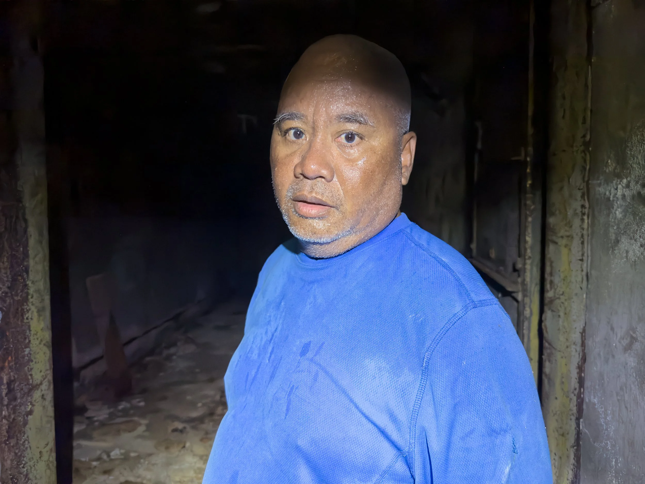  Alson Kelen, former resident of Bikini, walking away from a once two story concrete structure built close to the Bravo detonation’s ground zero. 
