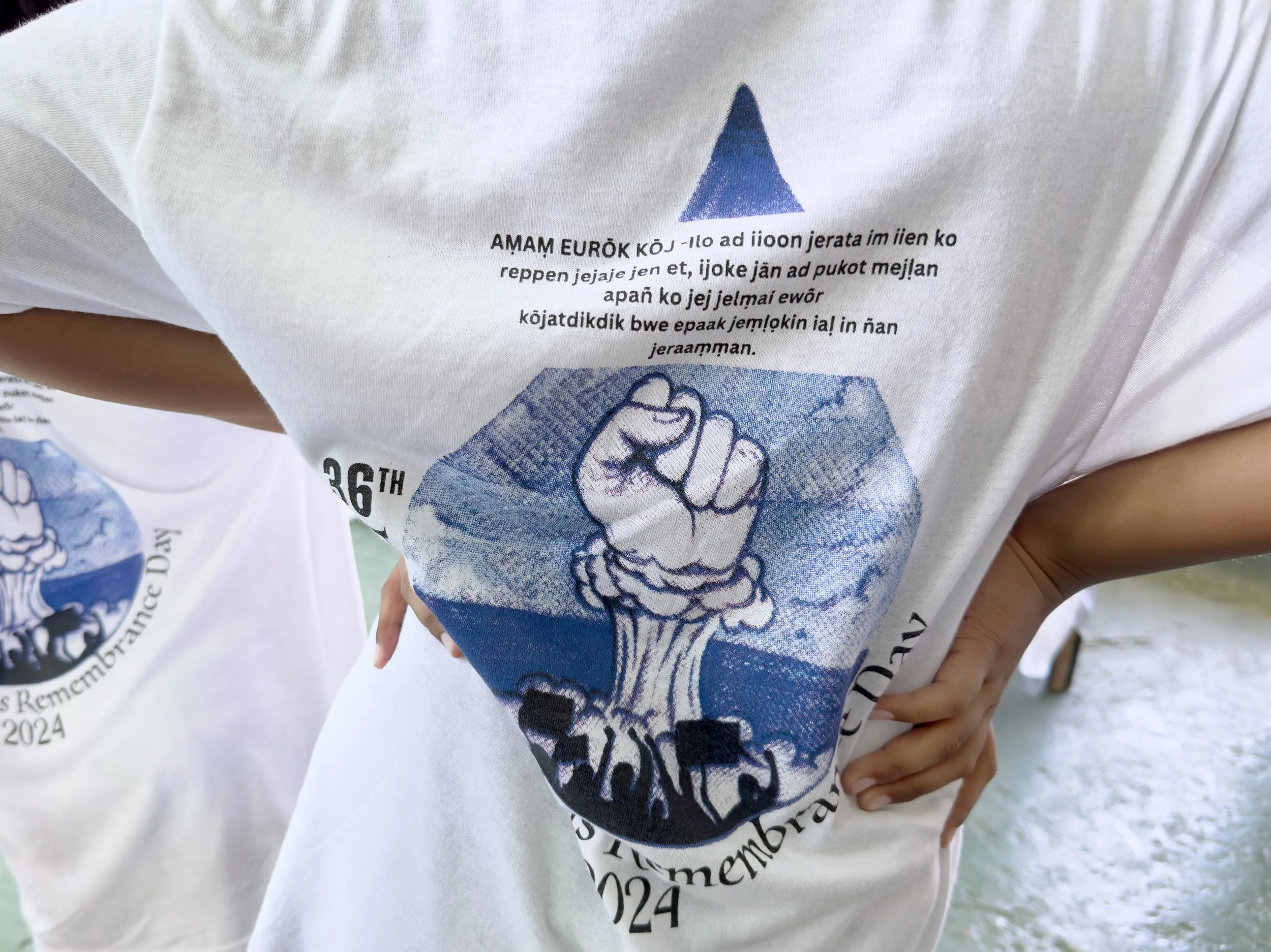 Young woman wearing a nuclear fist T-shirt commemorating Nuclear Victims Remembrance Day, March 1, 2024. 
