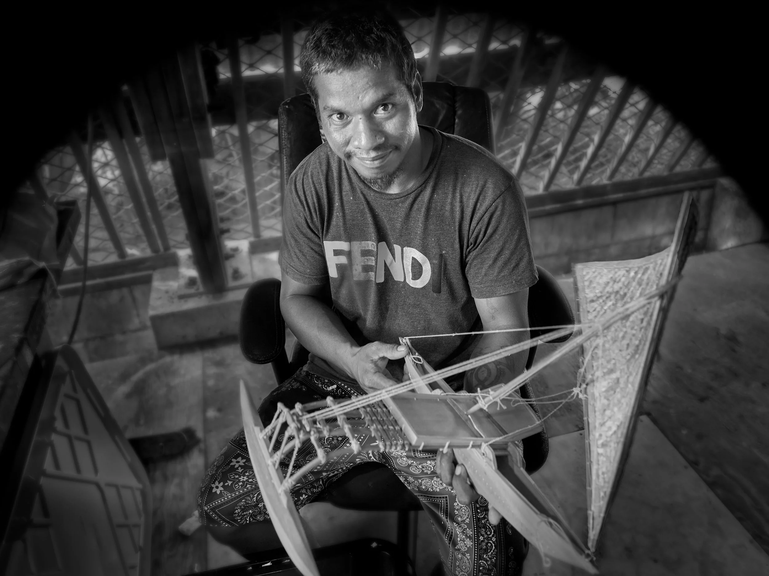  Canoe builder Clancy Taika at Waan Aelõñ in Ma (WAM) showing a model of a traditional Marshallese canoe. 
