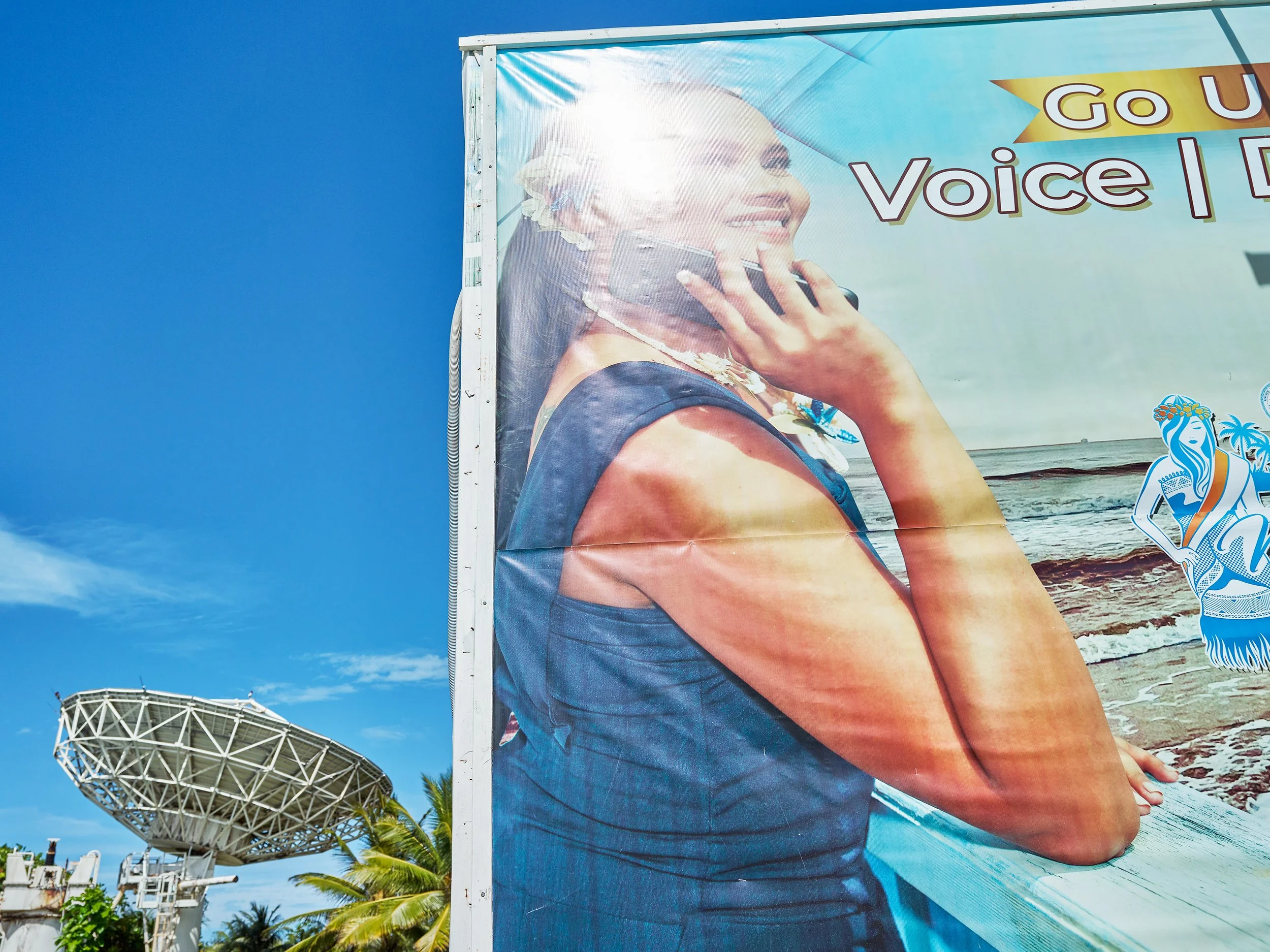  Satellite dish and billboard advertising cell phone coverage, near the capitol on Majuro. 
