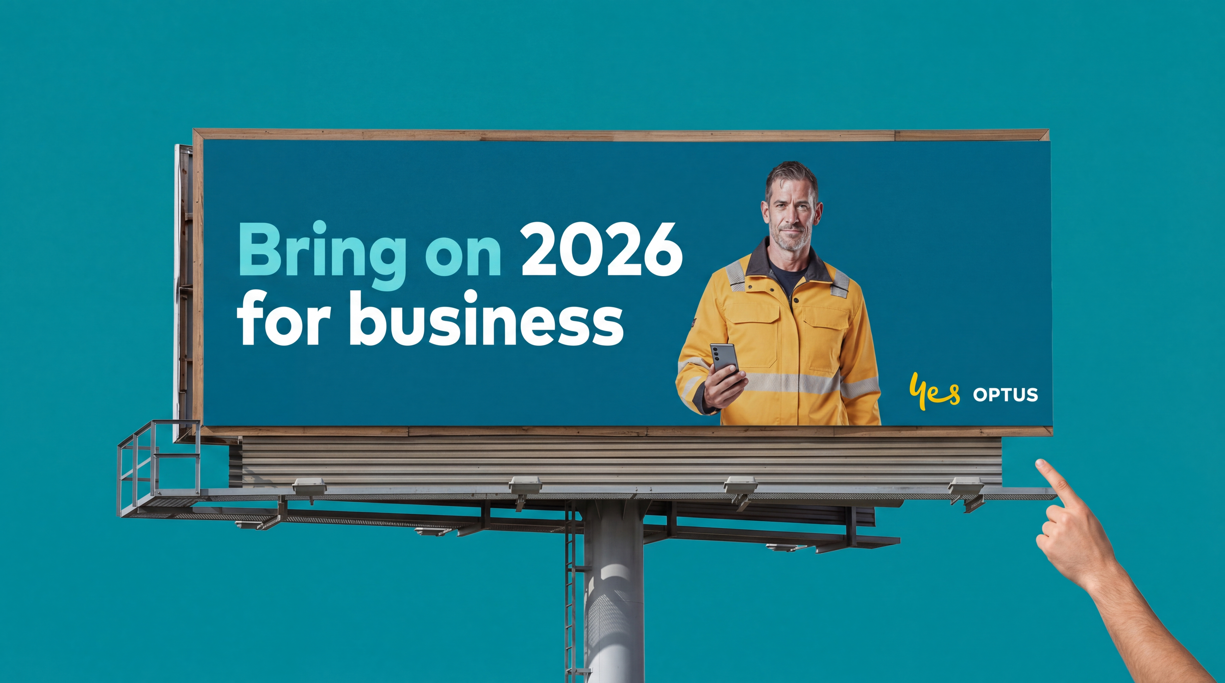 Billboard with a man in a high-visibility yellow and gray jacket holding a smartphone, with the text 'Bring on 2026 for business' and the Optus logo, against a blue background.