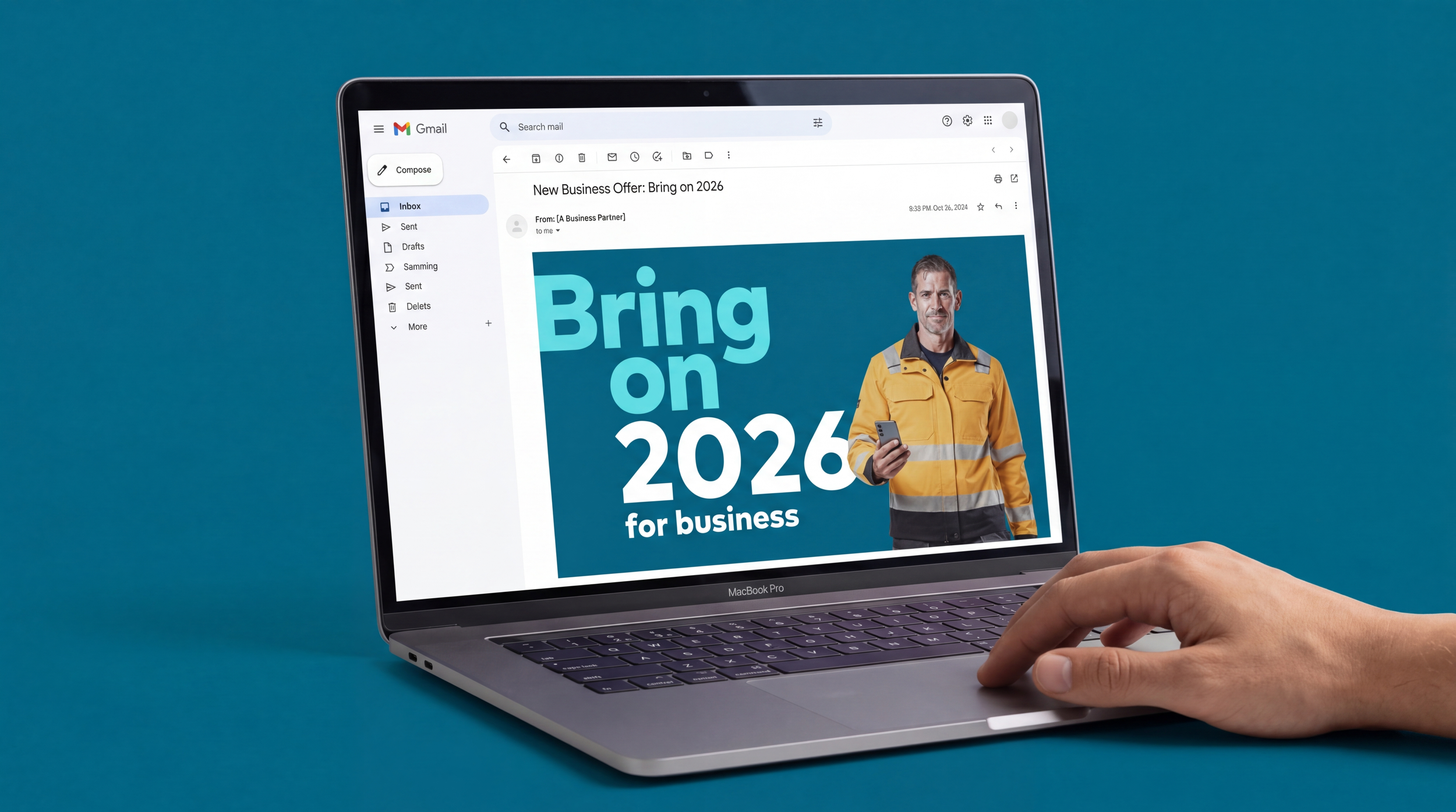 A person holding a laptop displaying an email about a business offer titled 'Bring on 2026 for business,' with a man in a yellow jacket holding a smartphone on the screen.