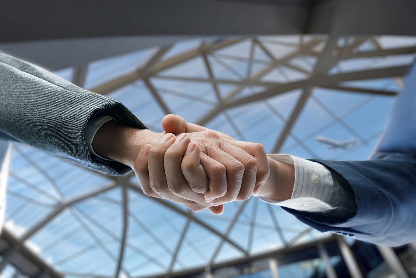 shaking hands at airport.png
