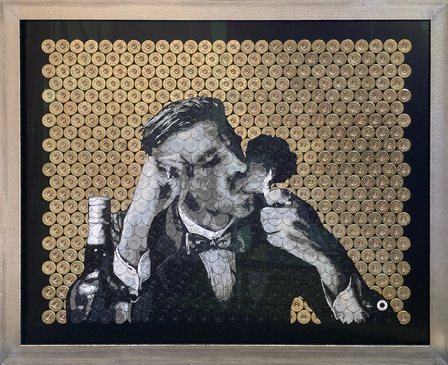 Artwork created with bullet shells depicting a worried woman with her hand on her forehead.