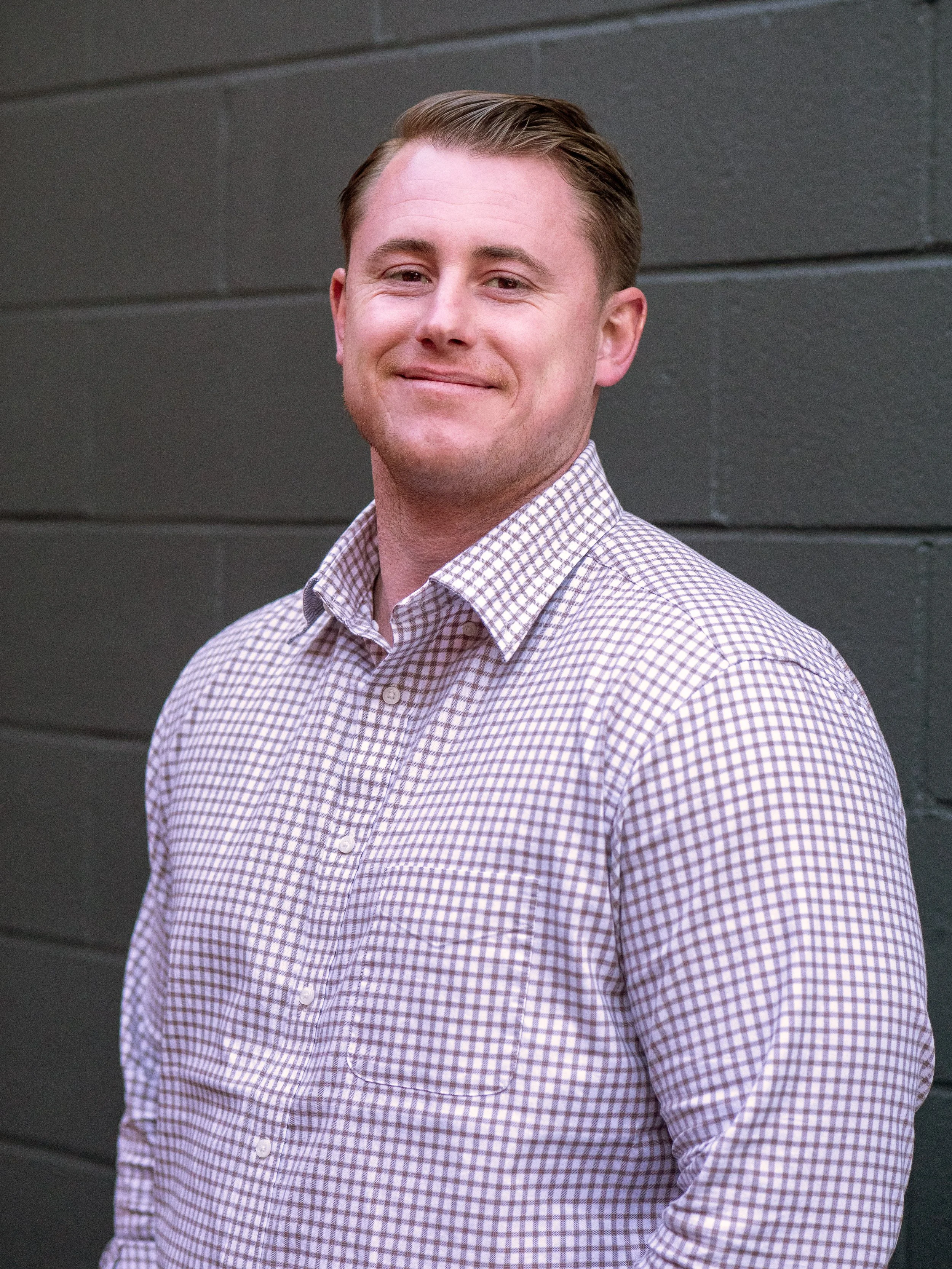 Silhouette of a person with short hair and wearing a jacket.