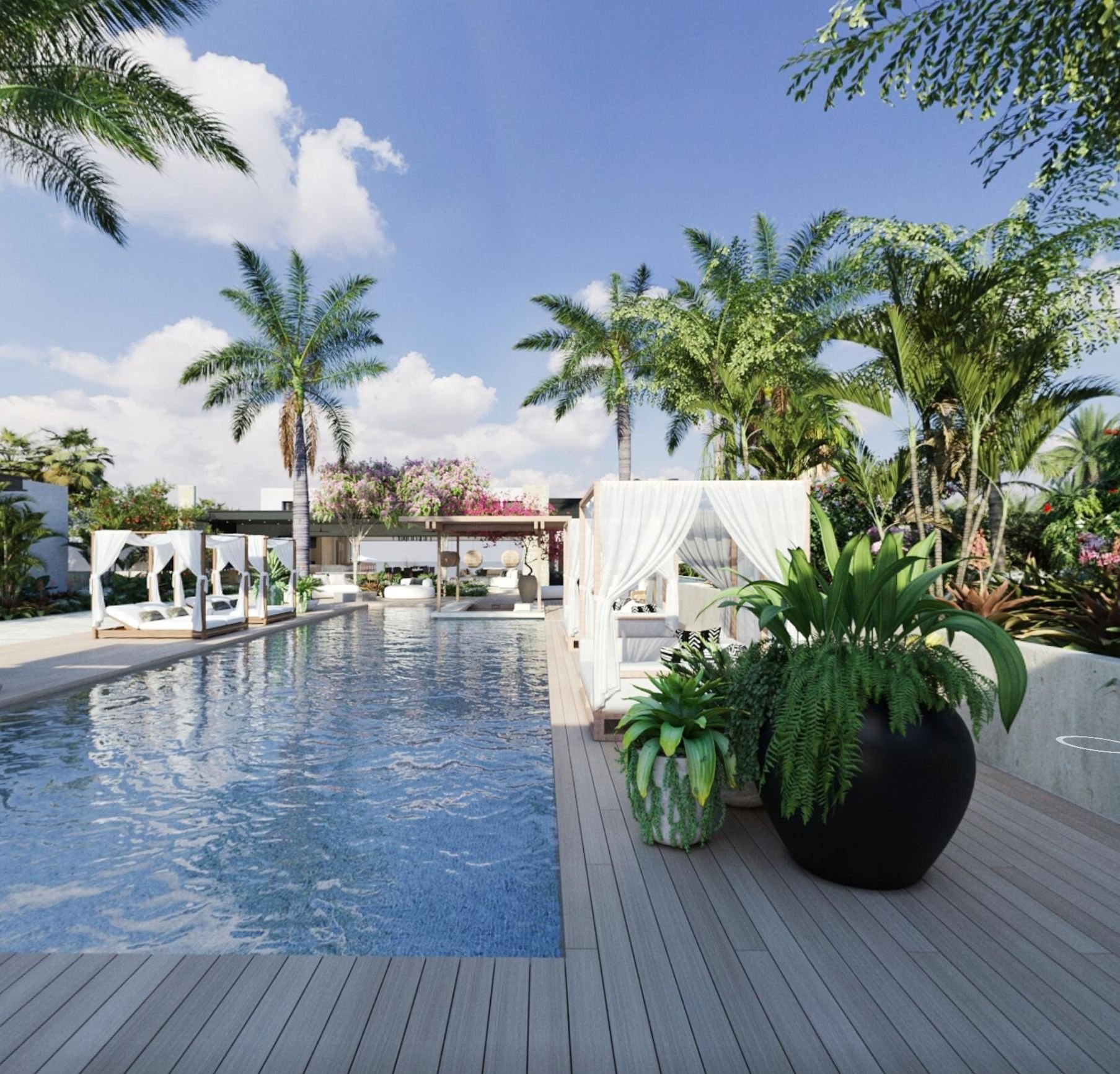 Luxurious outdoor poolside patio with white cabanas and lounge chairs, surrounded by lush green palm trees and tropical plants under a bright blue sky.