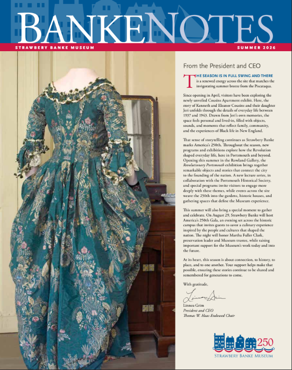 A museum display featuring a vintage blue and gold dress on a dress form, beside a wooden cabinet, with a colorful newsletter page titled 'Bank Notes' from the Strawberry Banke Museum Summer 2026 issue.