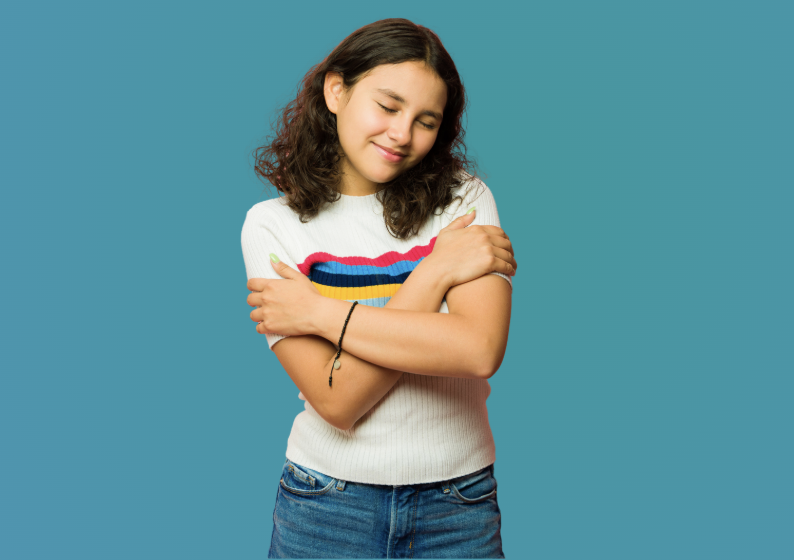 Teen girl struggling with depression, ADHD, autism, and other concerns. Against a turquoise background, a white child with red hair and a bright yellow sweater smiles and embraces herself.
