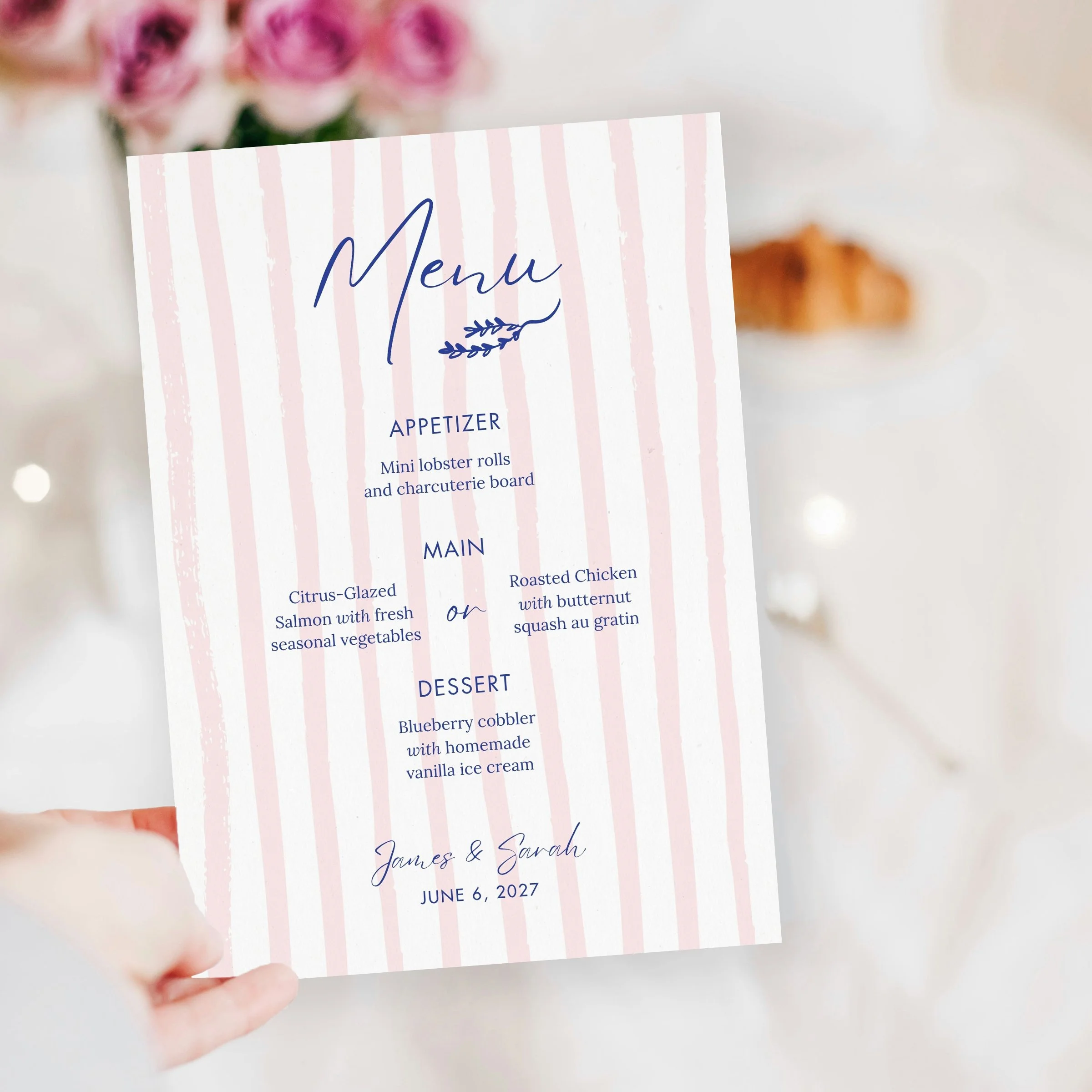 Hand holding menu over flowers and croissant copy.jpg