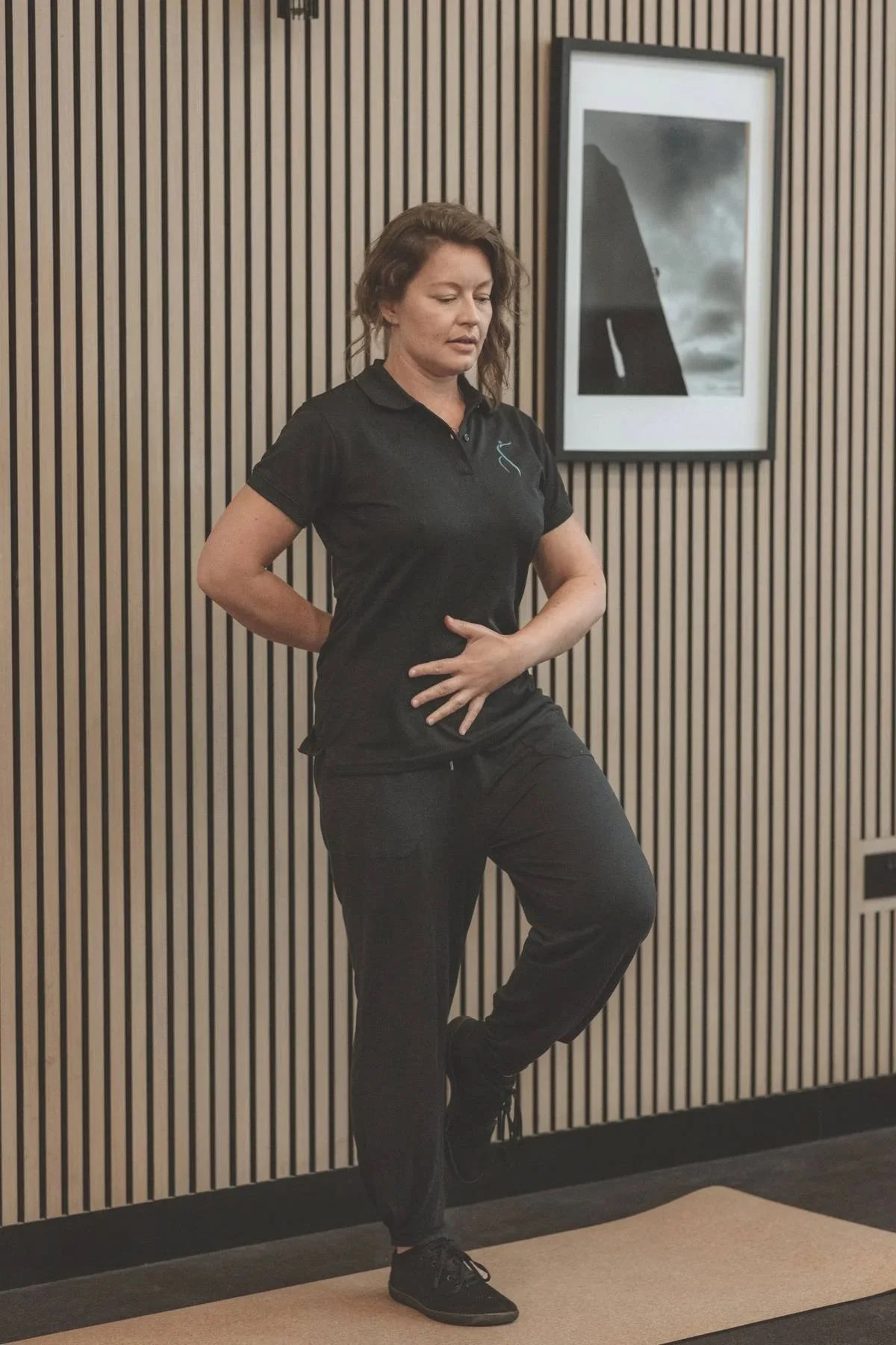Picture of Laura Rutherford performing a Pilates stability exercise standing on one leg.