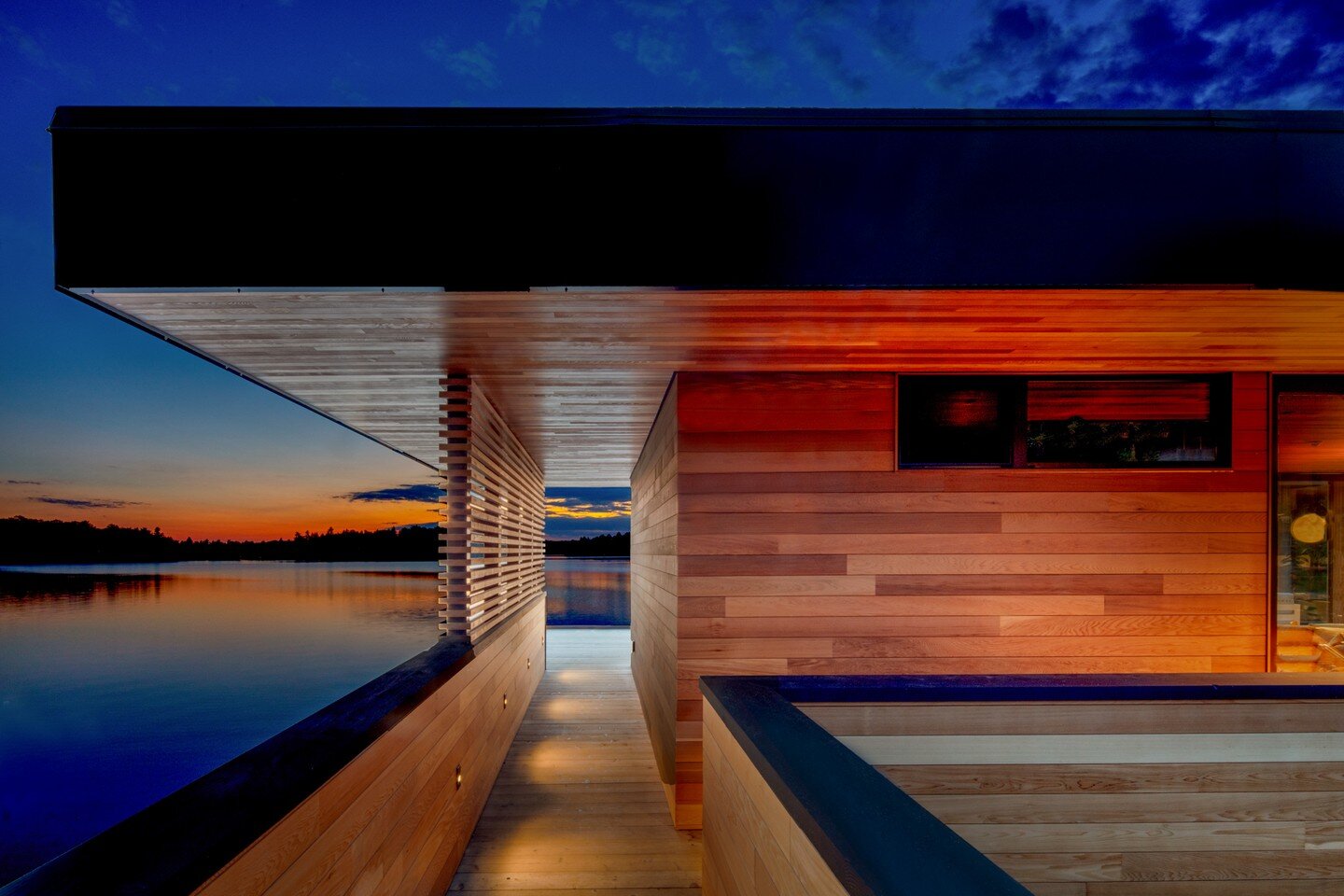 Lake Muskoka luxury boathouse at sunset