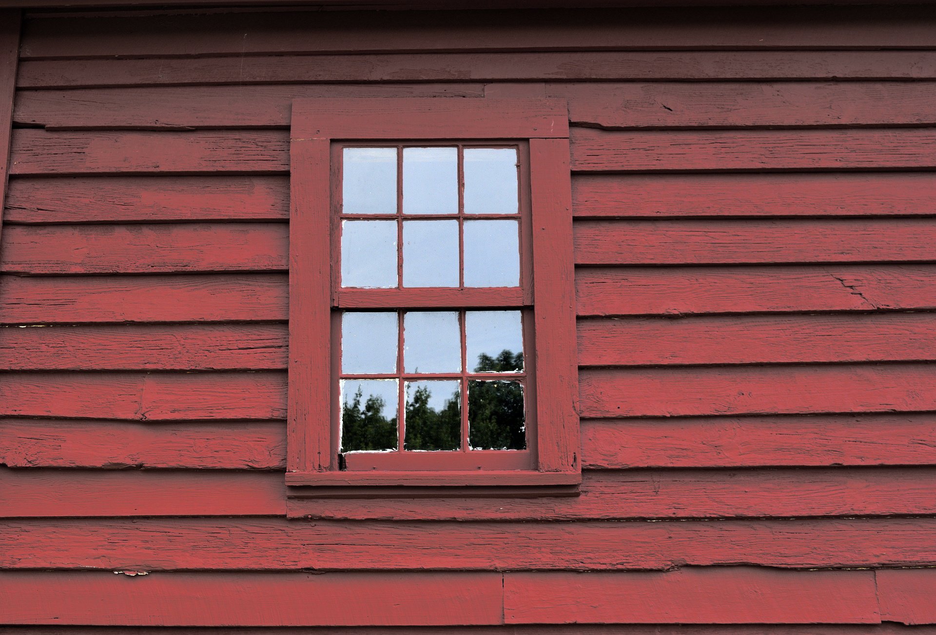 Window in red wooden wall