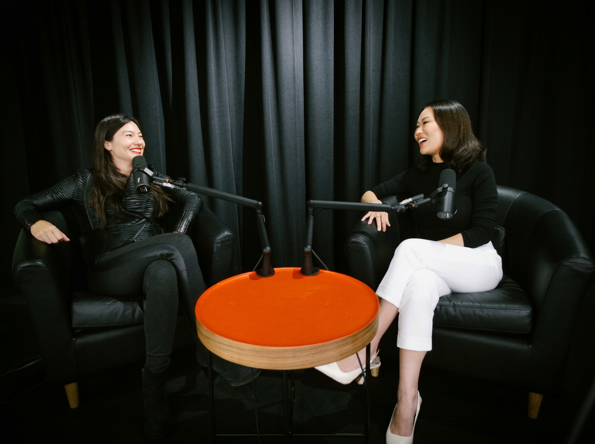 2 women doing a podcast in black chairs