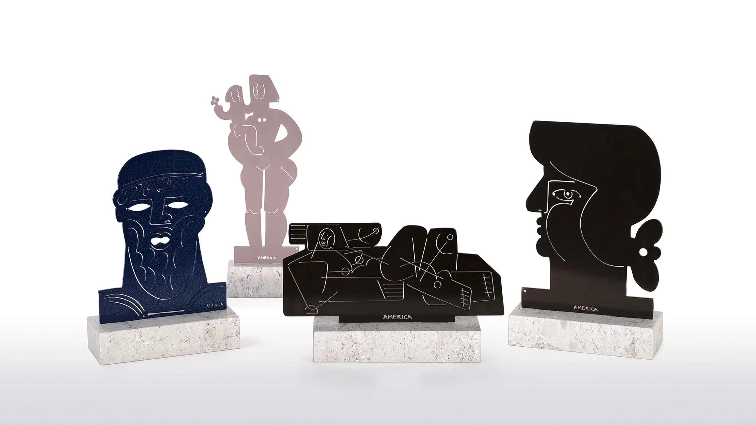 America Martin's cut steel sculptures — bold figurative forms and portrait subjects in navy, blush, and black on marble bases. Contemporary sculpture by the Colombian-American artist.