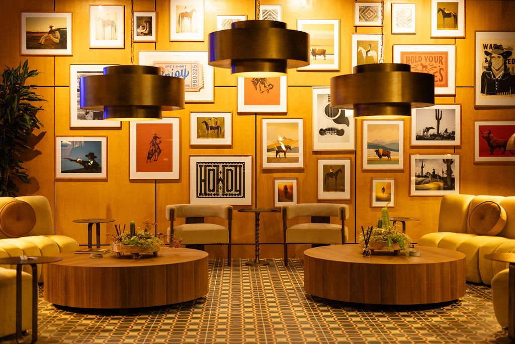 Warm lighting, framed artwork, and lounge seating at The Outlawyer.