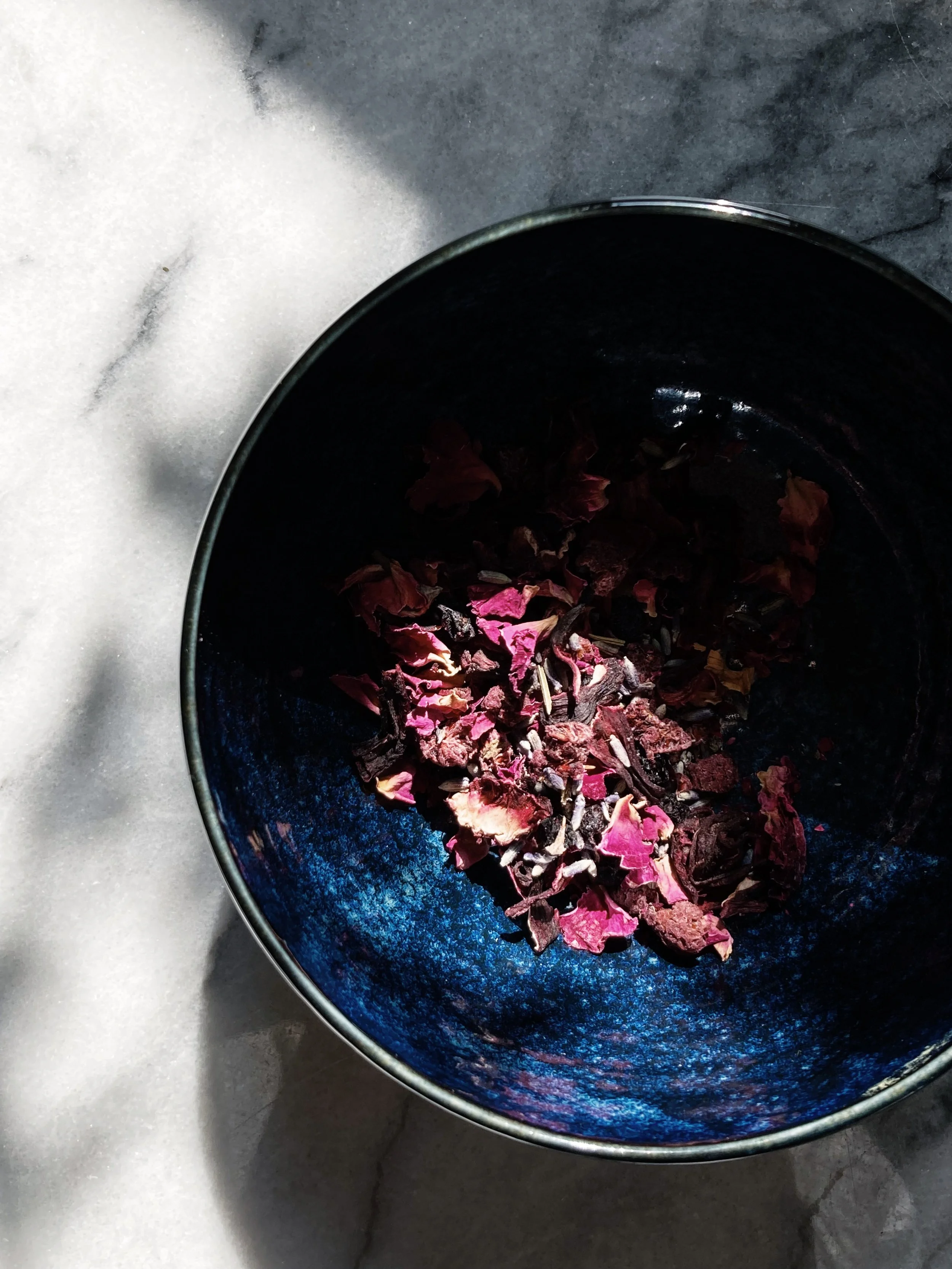 marble & milkweed | hibiscus rose tisane in a blue bowl May 2023.jpg