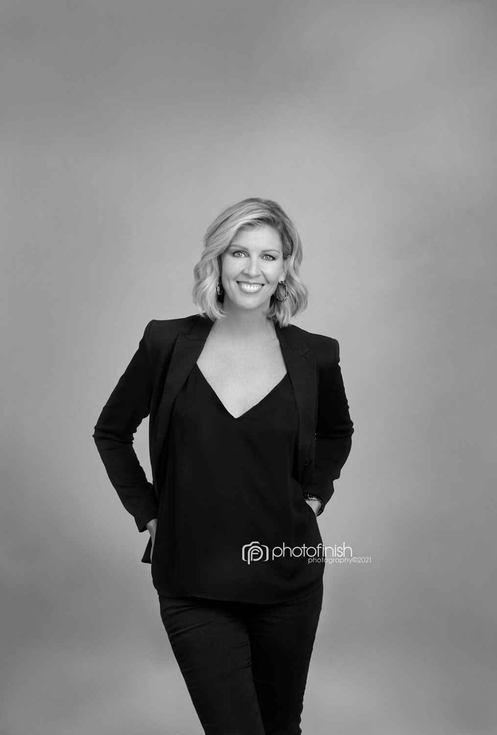 Catherine Cox wearing a black suit for her personal branding photo session in Photo Finish Photography’s Lane Cove studio