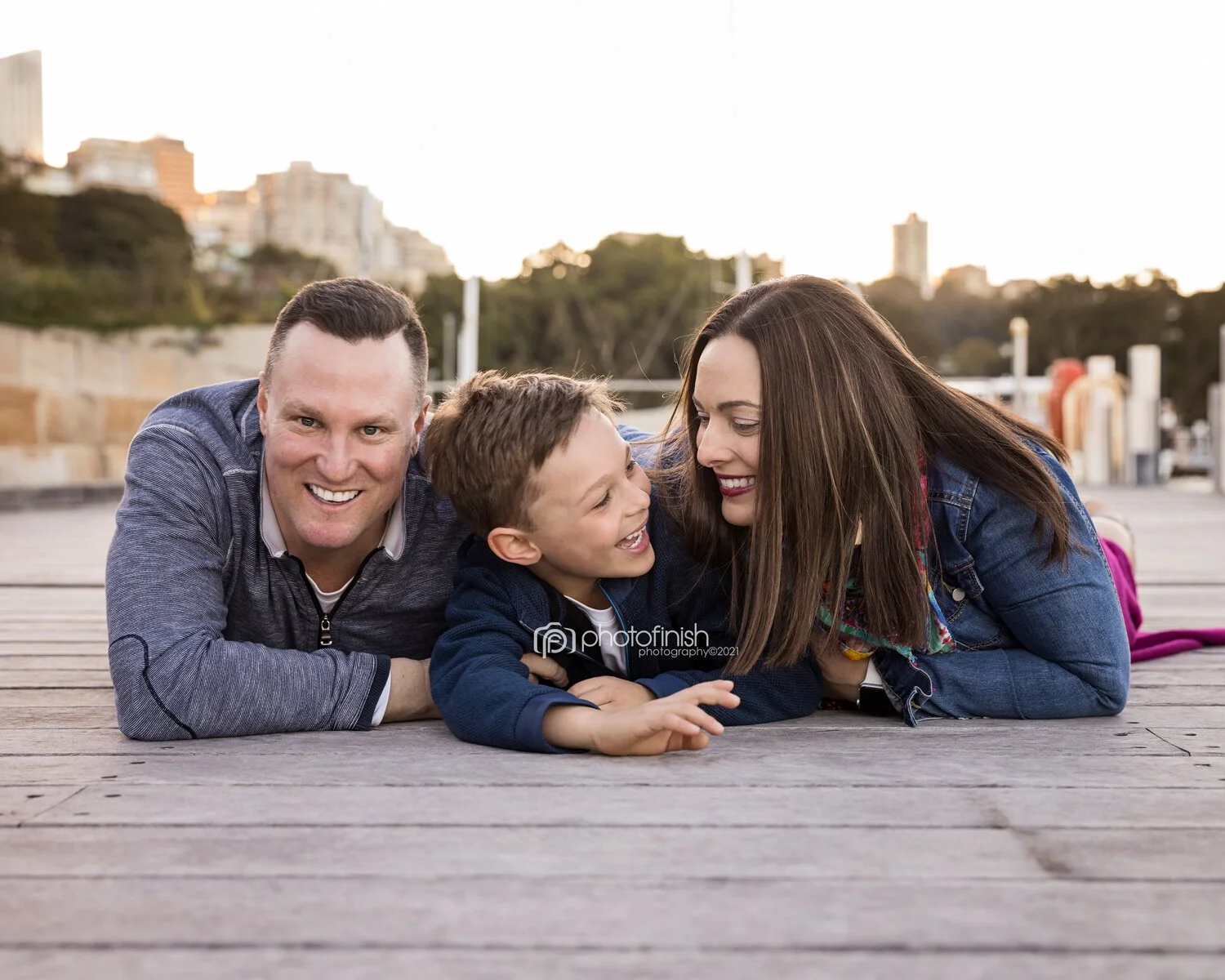 Family lying on timber wharf shot at family photo session at Sub Platypus Base in North Sydney