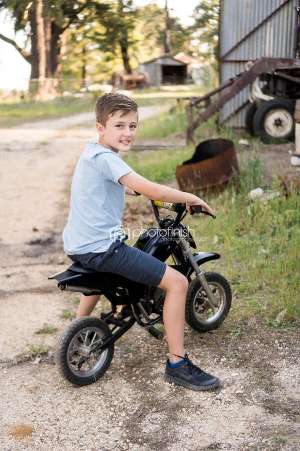 Boy on a motorbike on the farm