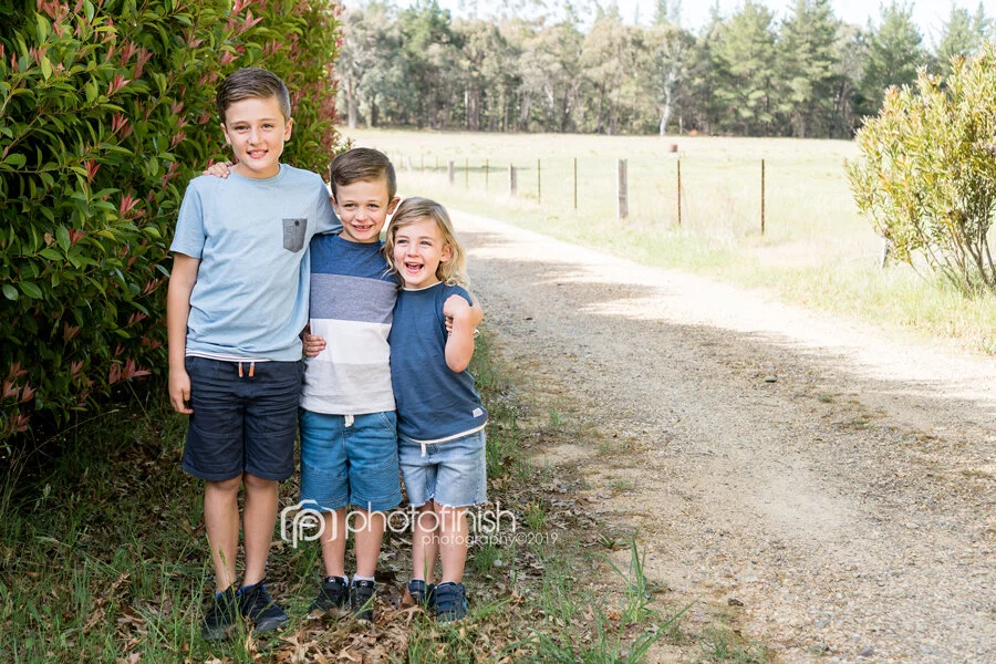 Three smiling brothers on a farm in Orange NSW