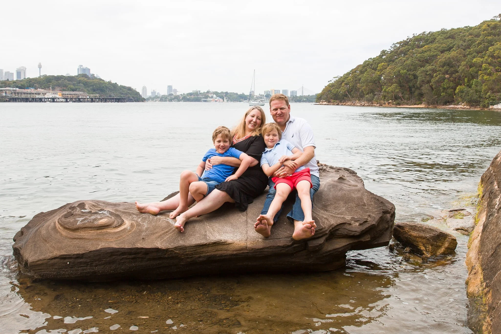 Sydney family enjoying a relaxed outdoor photo session at Berry Island Reserve, with barefoot kids playing and natural smiles captured in golden light